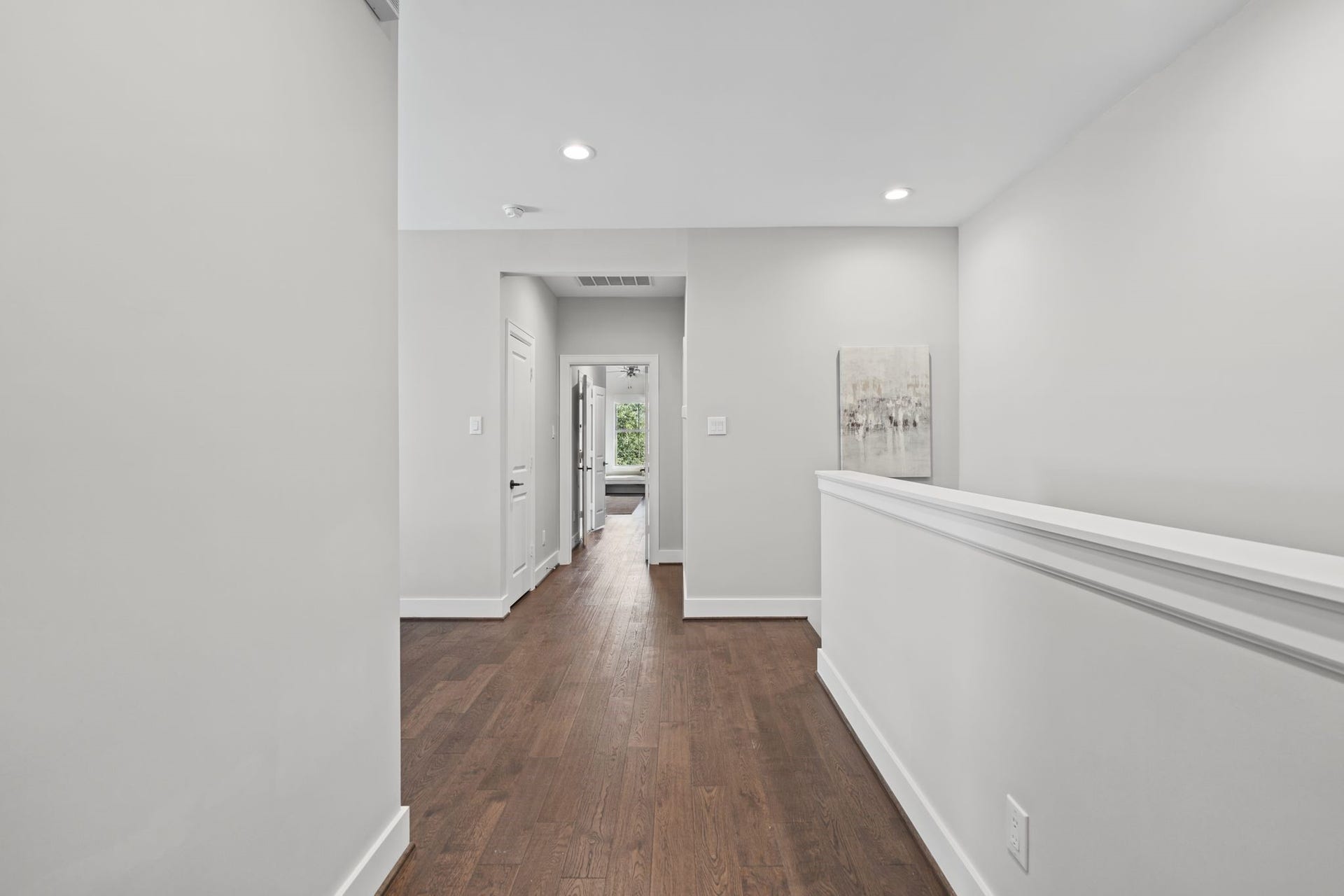 1538 Vermont Street, #A, Houston, TX 77006 Clean lines, classic wall detailing, and continuous wood flooring create a polished transition between the home's private living quarters.