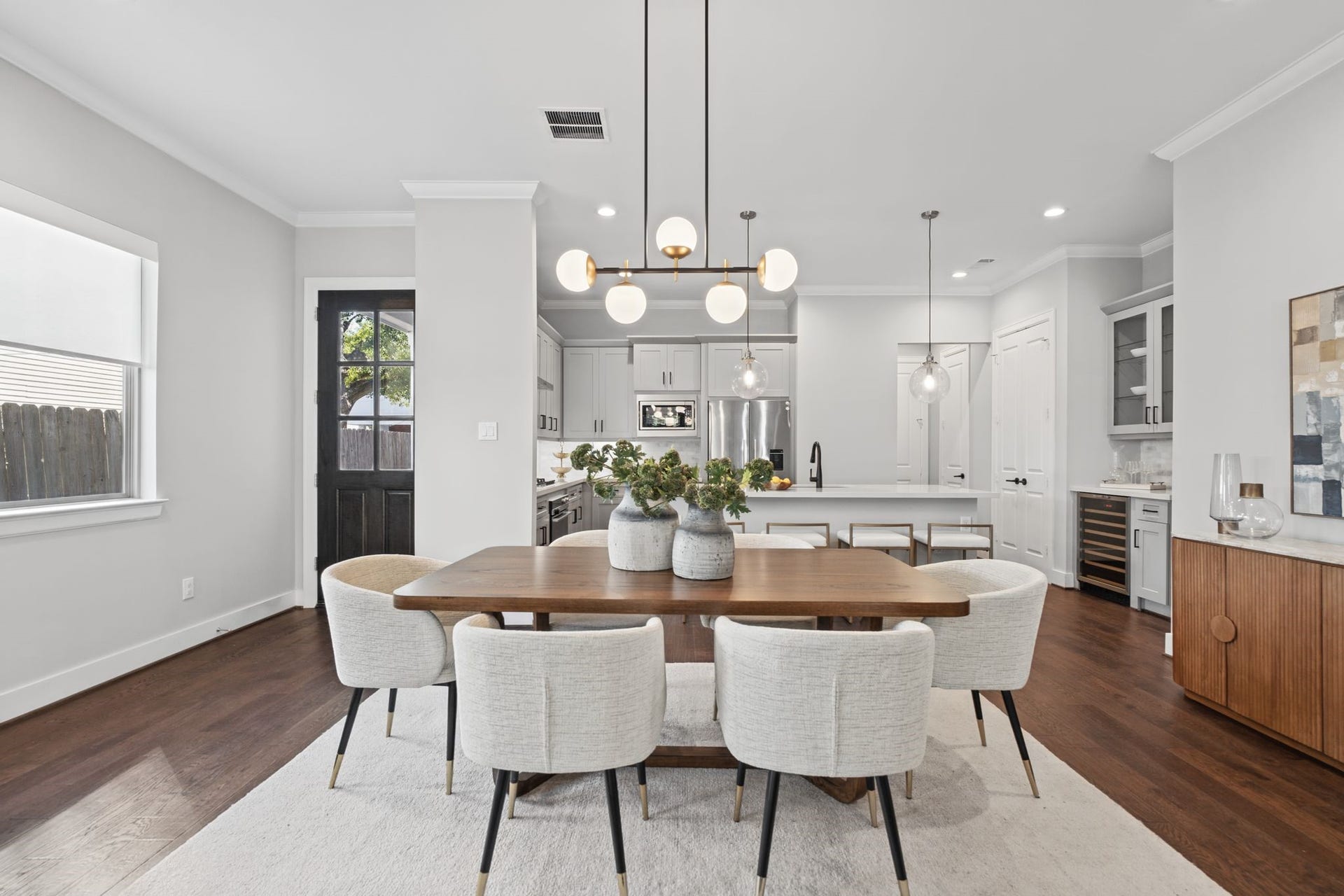 1538 Vermont Street, #A, Houston, TX 77006 A sophisticated dining space pairs a warm wood table with upholstered seating and statement lighting, seamlessly connecting to the surrounding living areas.