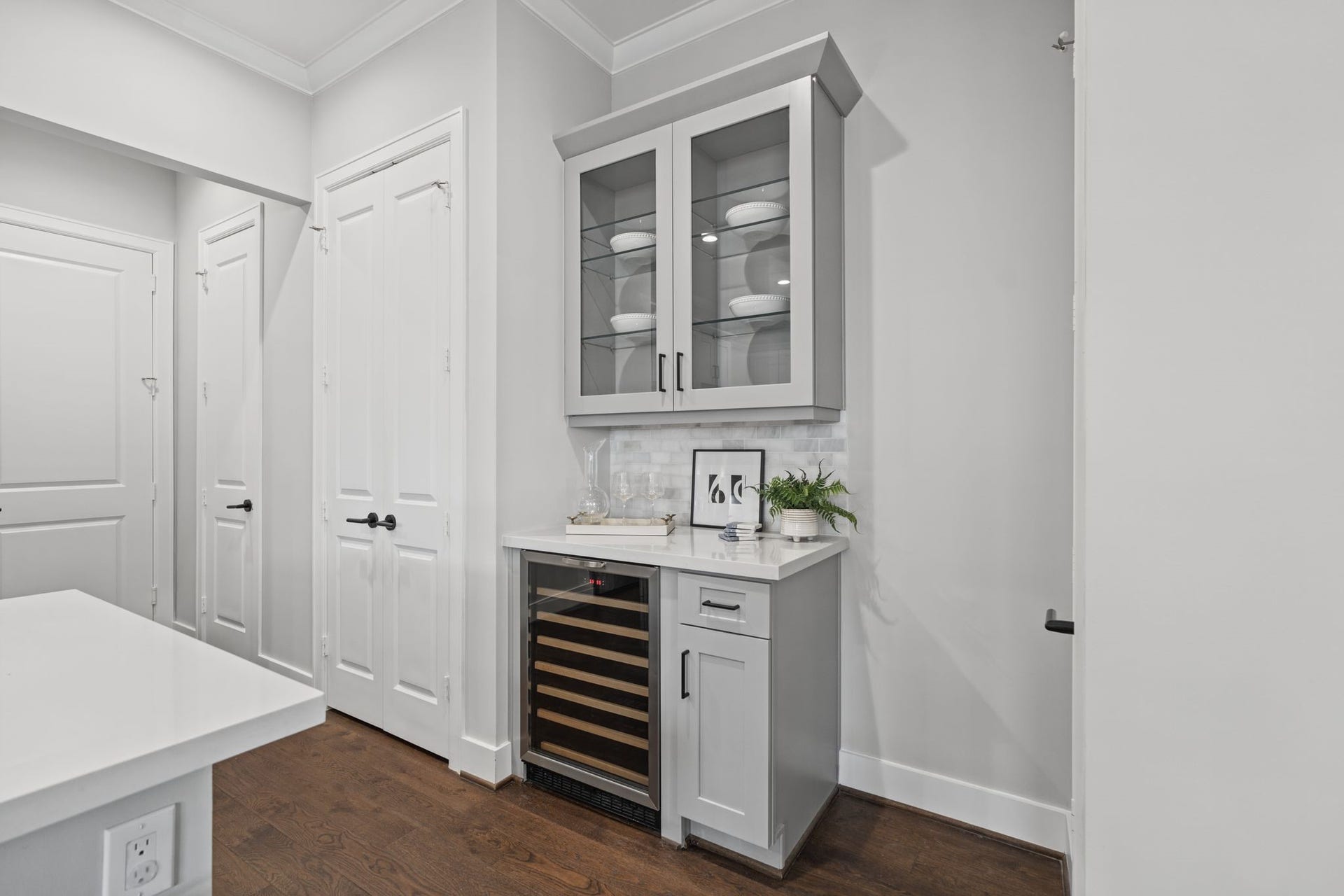 1538 Vermont Street, #A, Houston, TX 77006 A dedicated beverage area with glass-front cabinetry and a built-in wine refrigerator adds a thoughtful touch of convenience and entertaining appeal. Notice all the additional pantry and storage closets.