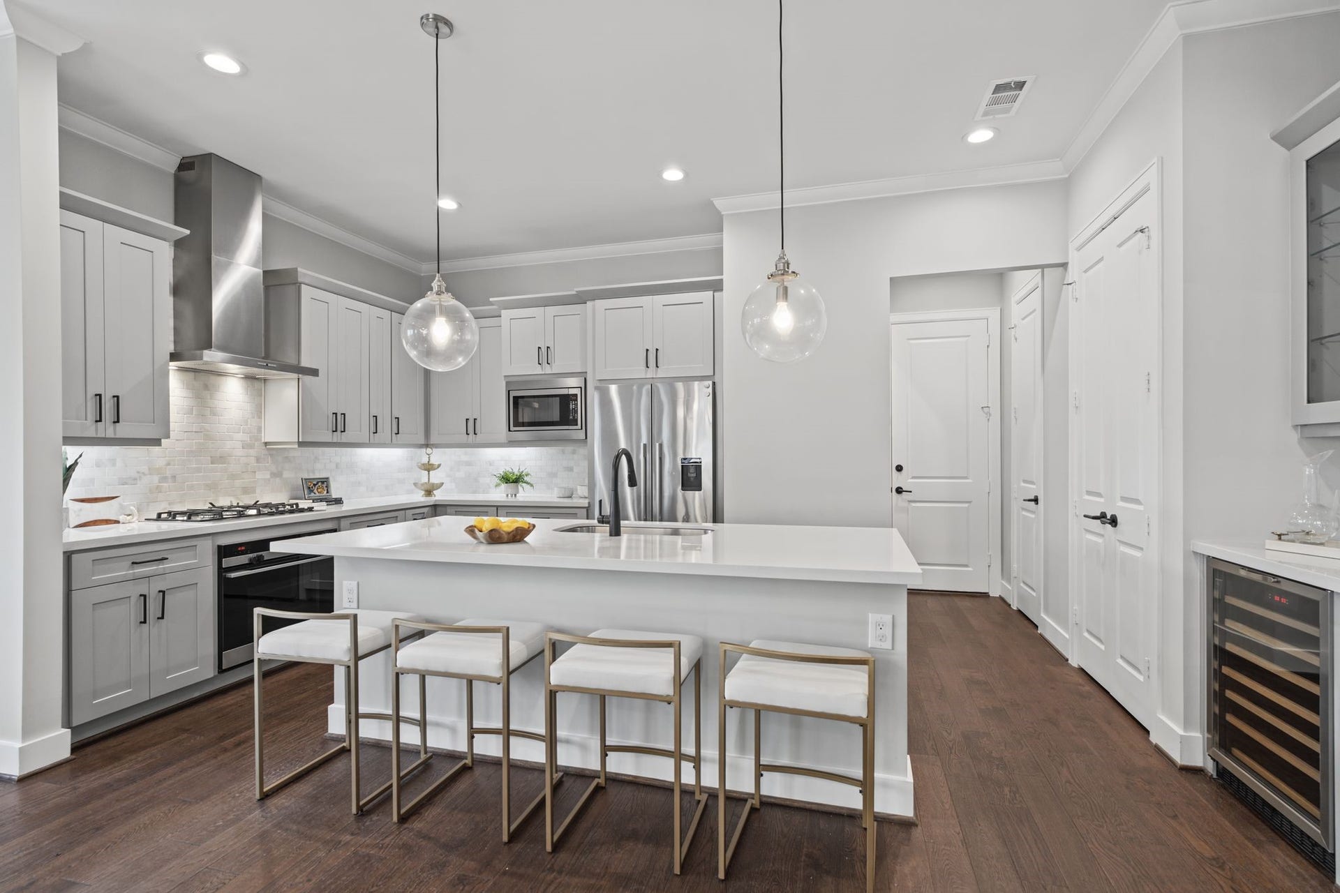 1538 Vermont Street, #A, Houston, TX 77006 A beautifully appointed kitchen features plenty of cabinetry, quartz countertops, stainless steel appliances, and contemporary pendant lighting, blending timeless appeal with modern functionality.