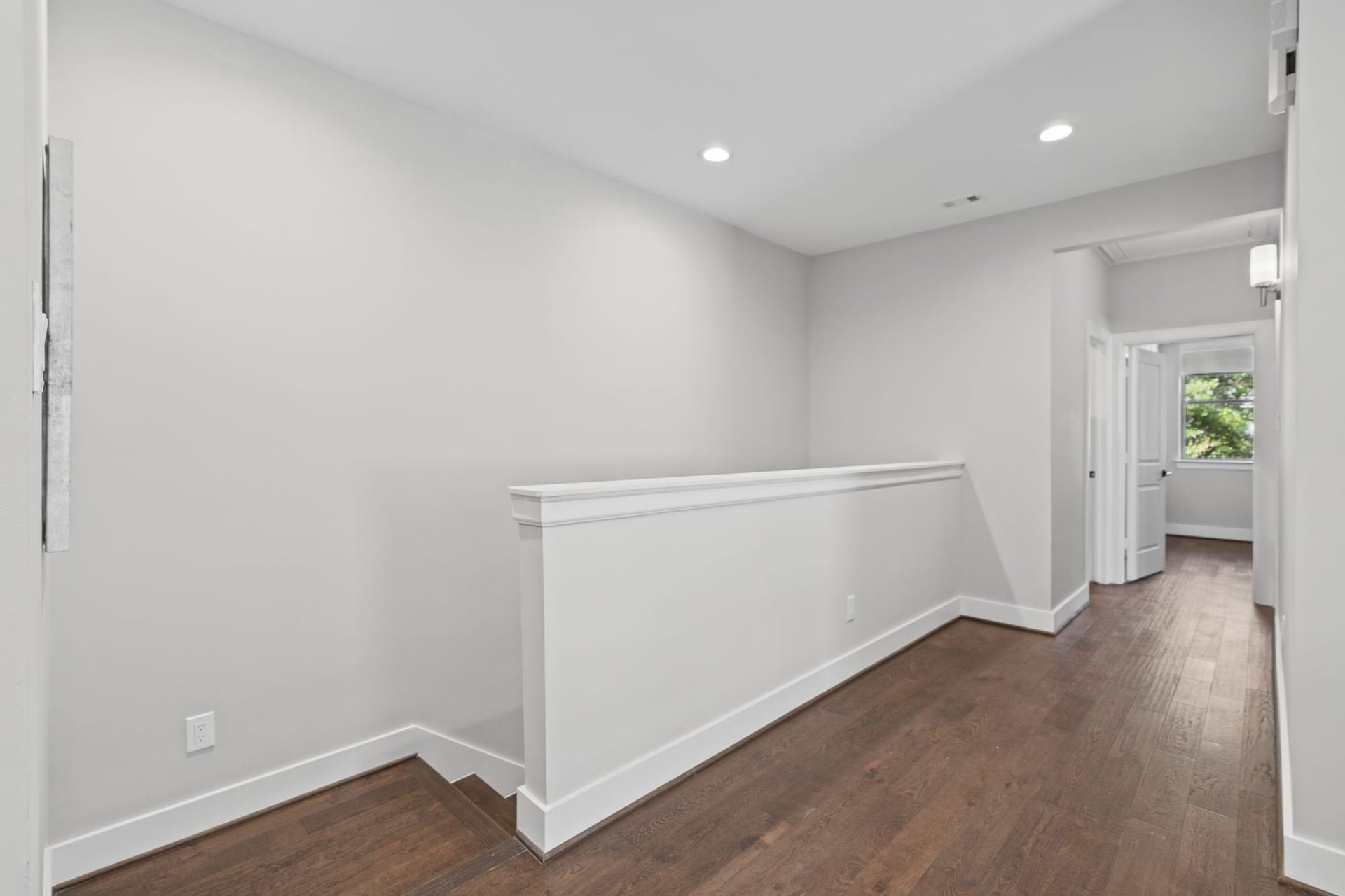 1538 Vermont Street, #A, Houston, TX 77006 An airy landing with classic trim details and warm wood flooring continues the home's cohesive, thoughtfully finished interior design.
