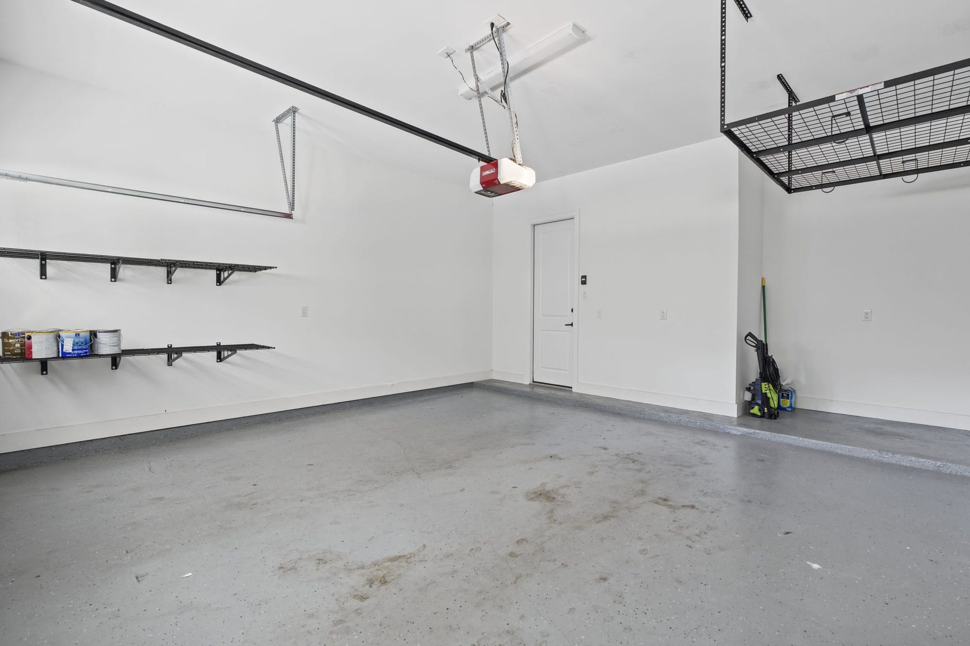 1538 Vermont Street, #A, Houston, TX 77006 A spacious garage with organized wall-mounted storage and overhead racks provides practical space for vehicles, equipment, and seasonal essentials.