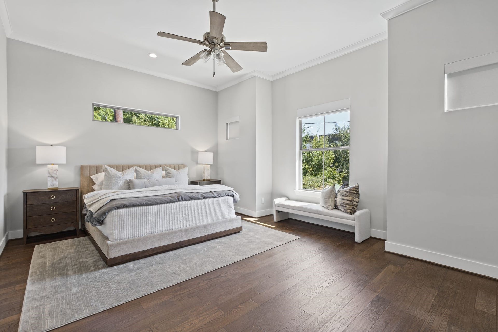 1538 Vermont Street, #A, Houston, TX 77006 A spacious primary retreat combines soothing neutral tones, warm wood flooring, and generous windows to create a serene escape at day's end.