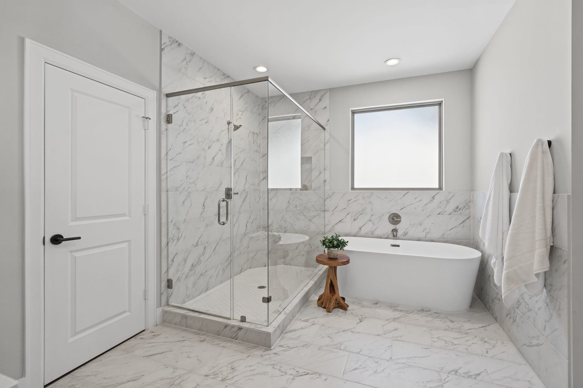 1538 Vermont Street, #A, Houston, TX 77006 A freestanding soaking tub and glass-enclosed walk-in shower create a beautiful focal point, complemented by sophisticated tilework and clean-lined finishes.