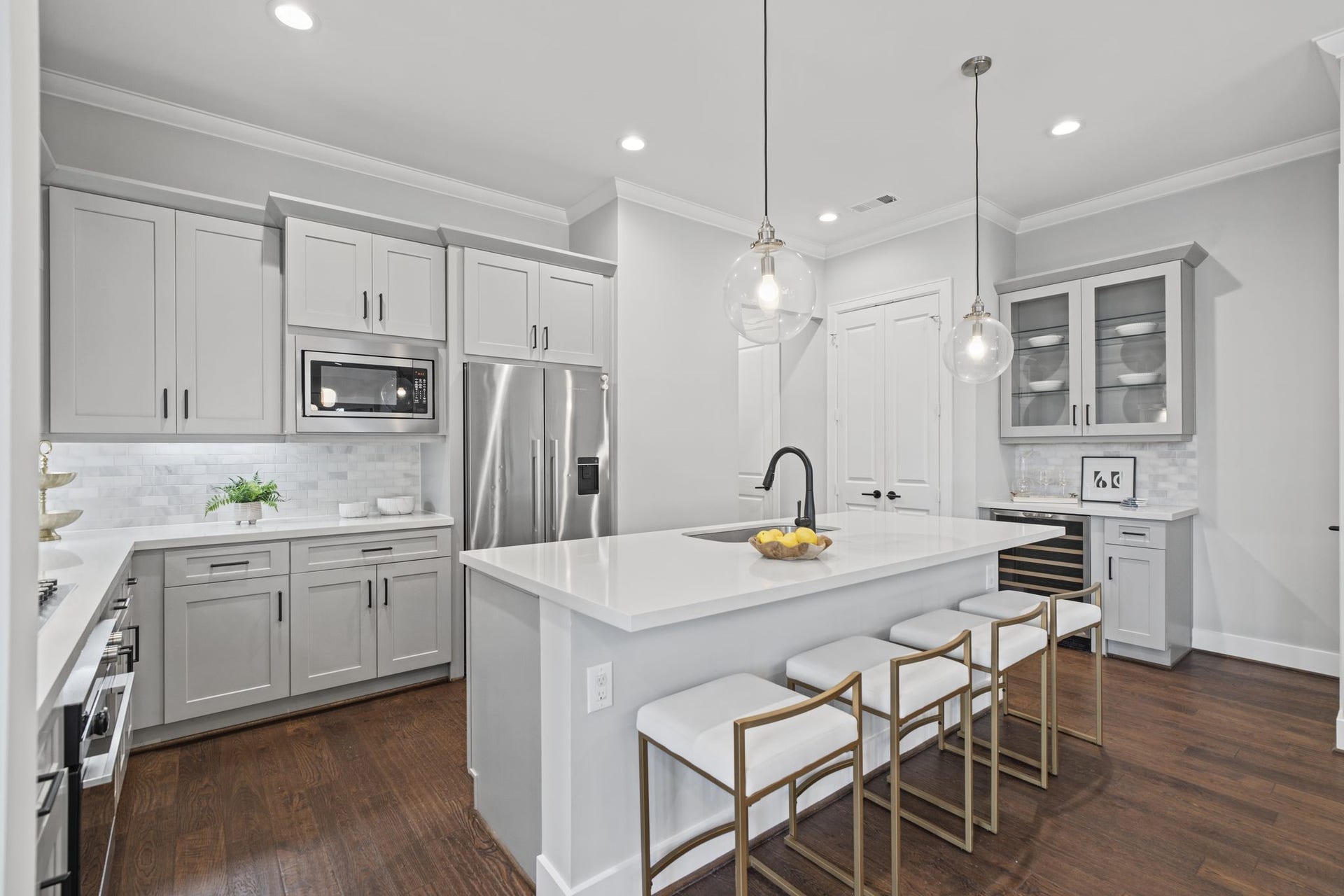 1538 Vermont Street, #A, Houston, TX 77006 Refined cabinetry, a sophisticated backsplash, and stainless steel appliances lend the kitchen a clean, tailored aesthetic.