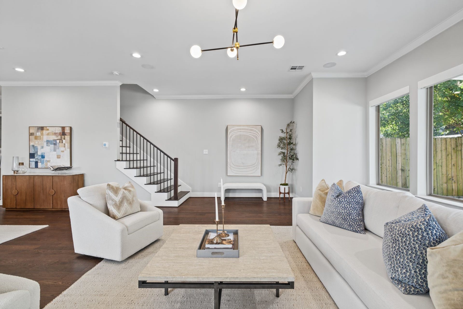 1538 Vermont Street, #A, Houston, TX 77006 Oversized windows invite abundant natural light into this welcoming living space, where understated finishes and elegant lighting create a relaxed yet refined ambiance.