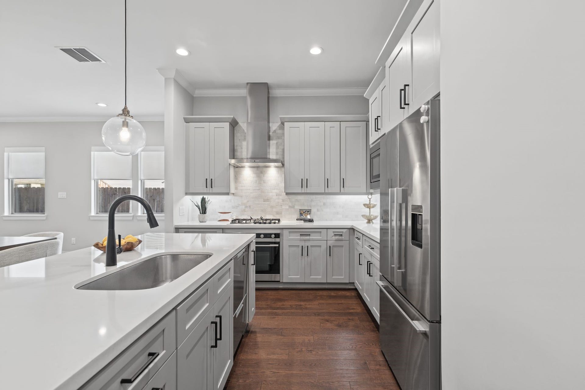 1538 Vermont Street, #A, Houston, TX 77006 An expansive island anchors the kitchen, offering generous preparation space, casual seating, and a polished focal point for gathering and entertaining.