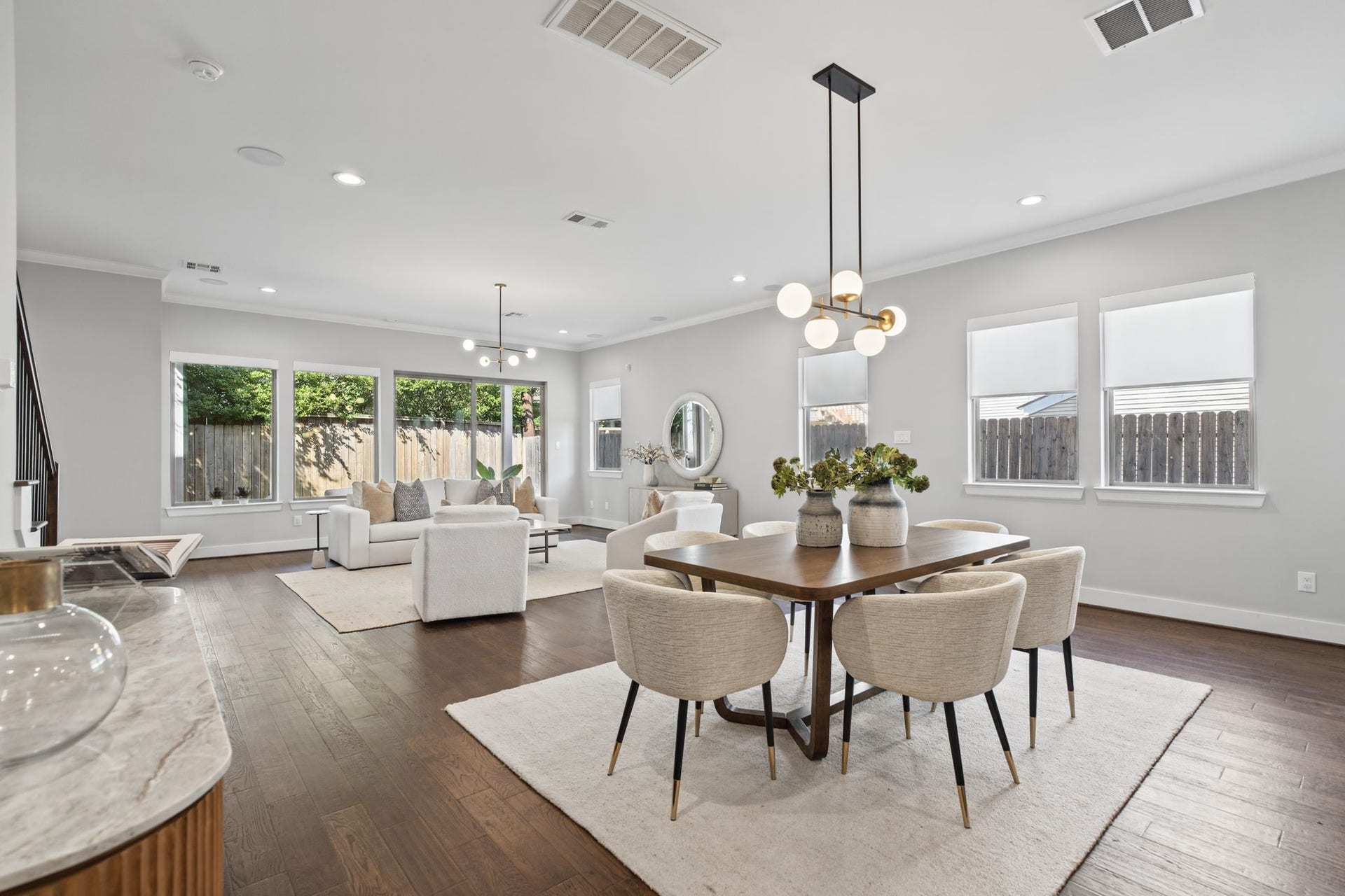 1538 Vermont Street, #A, Houston, TX 77006 A sophisticated dining space pairs a warm wood table with upholstered seating and statement lighting, seamlessly connecting to the surrounding living areas.