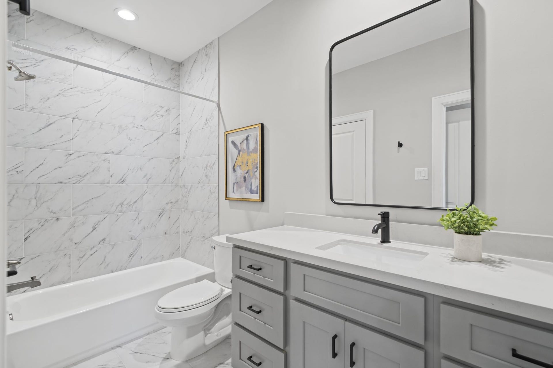 1538 Vermont Street, #A, Houston, TX 77006 Another spacious secondary bath with contemporary fixtures, a streamlined vanity, and elegant marble-look tile create a fresh, timeless finish in the secondary bath.