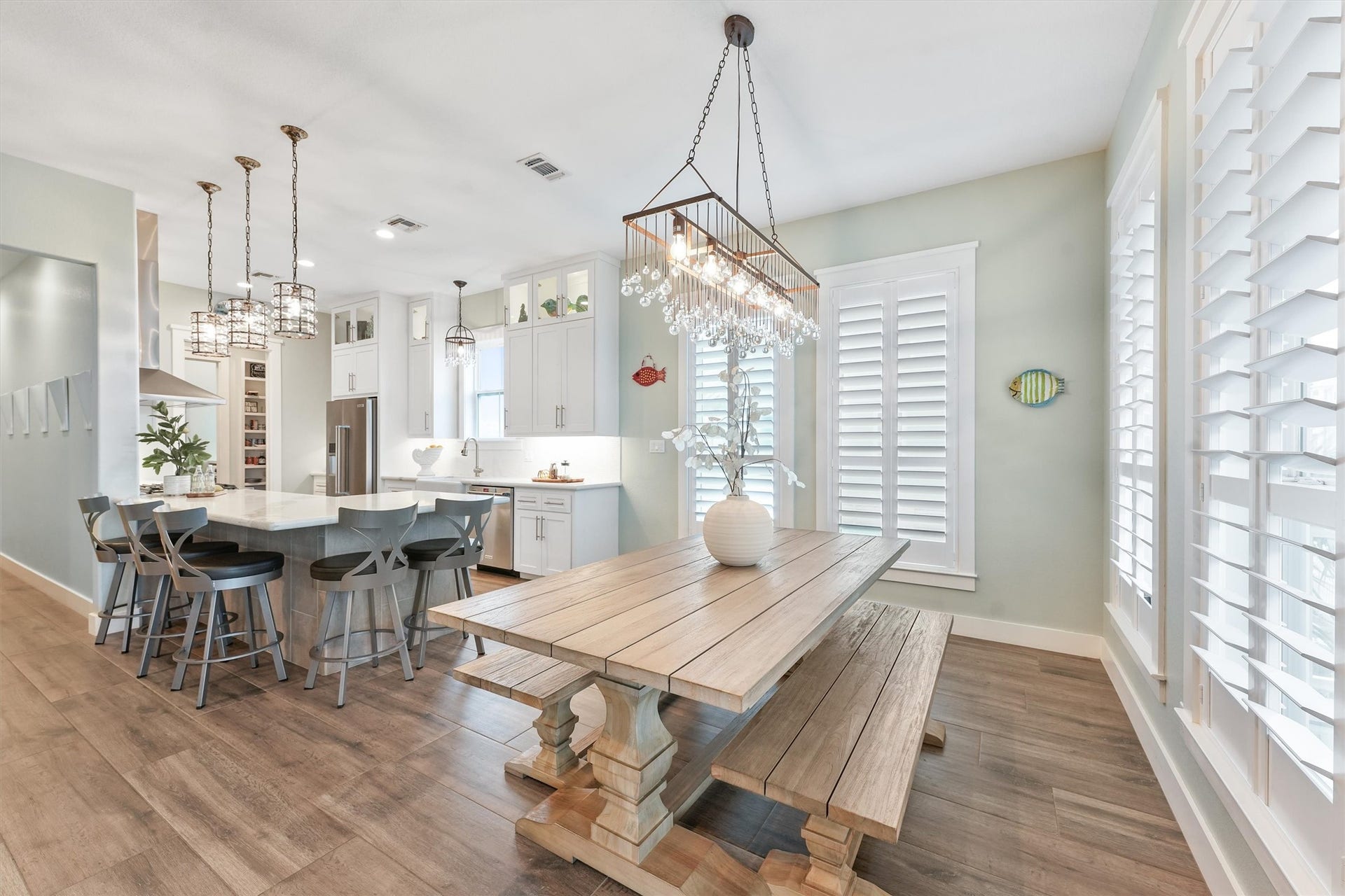 11418 Starfish Lane, Galveston, TX 77554 Wide-plank tile floors with a hardwood look grace the interior, complemented by Quartz countertops, a counter-height breakfast bar, and premium KitchenAid appliances in the open kitchen