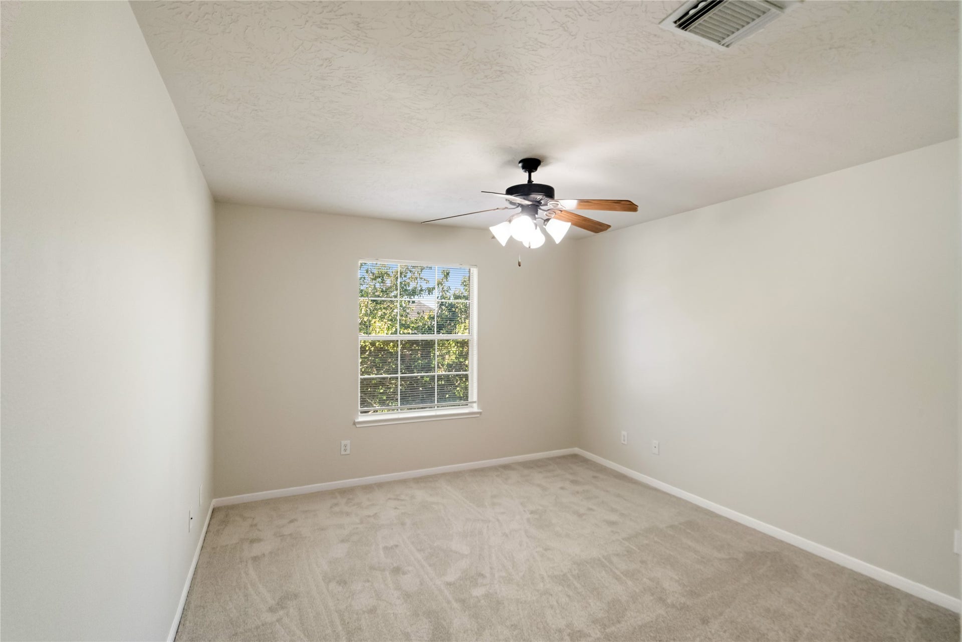Secondary bedroom with brand-new carpeting.