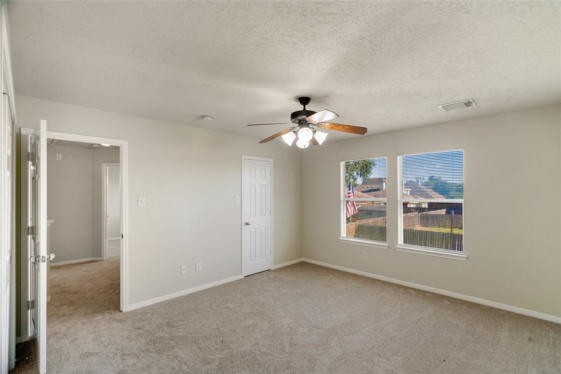 Primary Bedroom with natural light and NEw Carpet Flooring