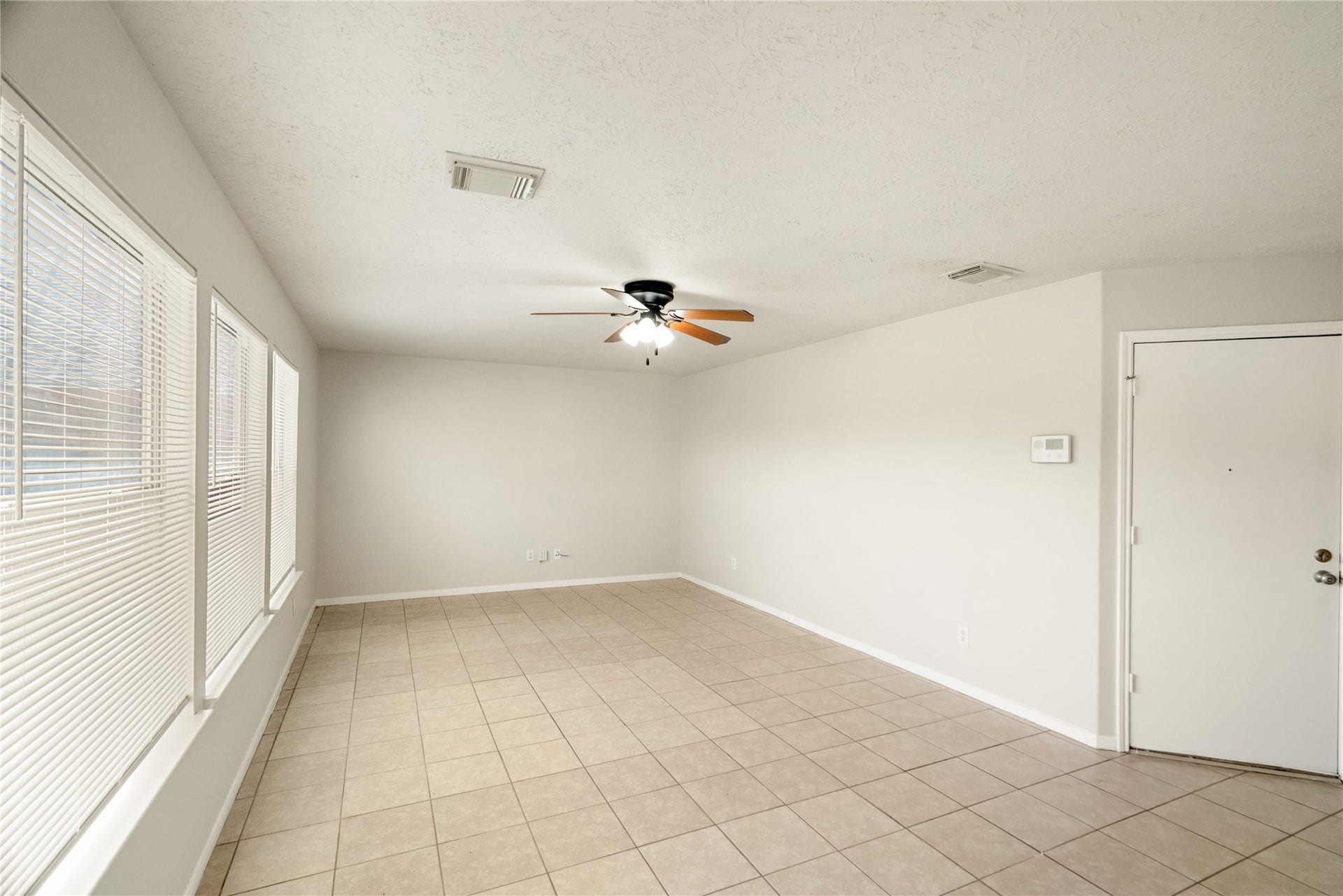 Spacious living room with natural light and an open floor plan.