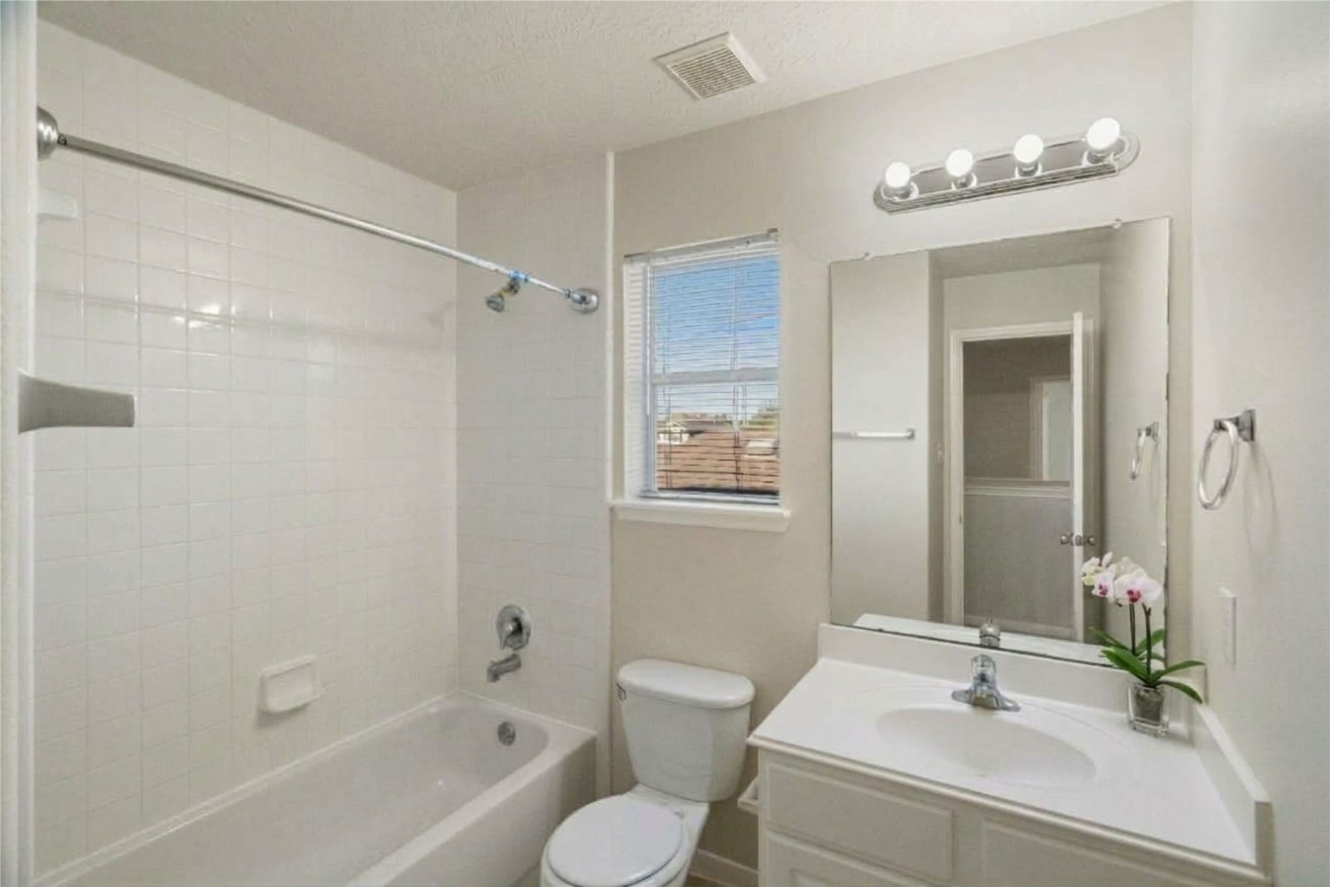 Secondary bathroom featuring a single vanity and a shower-tub combination.