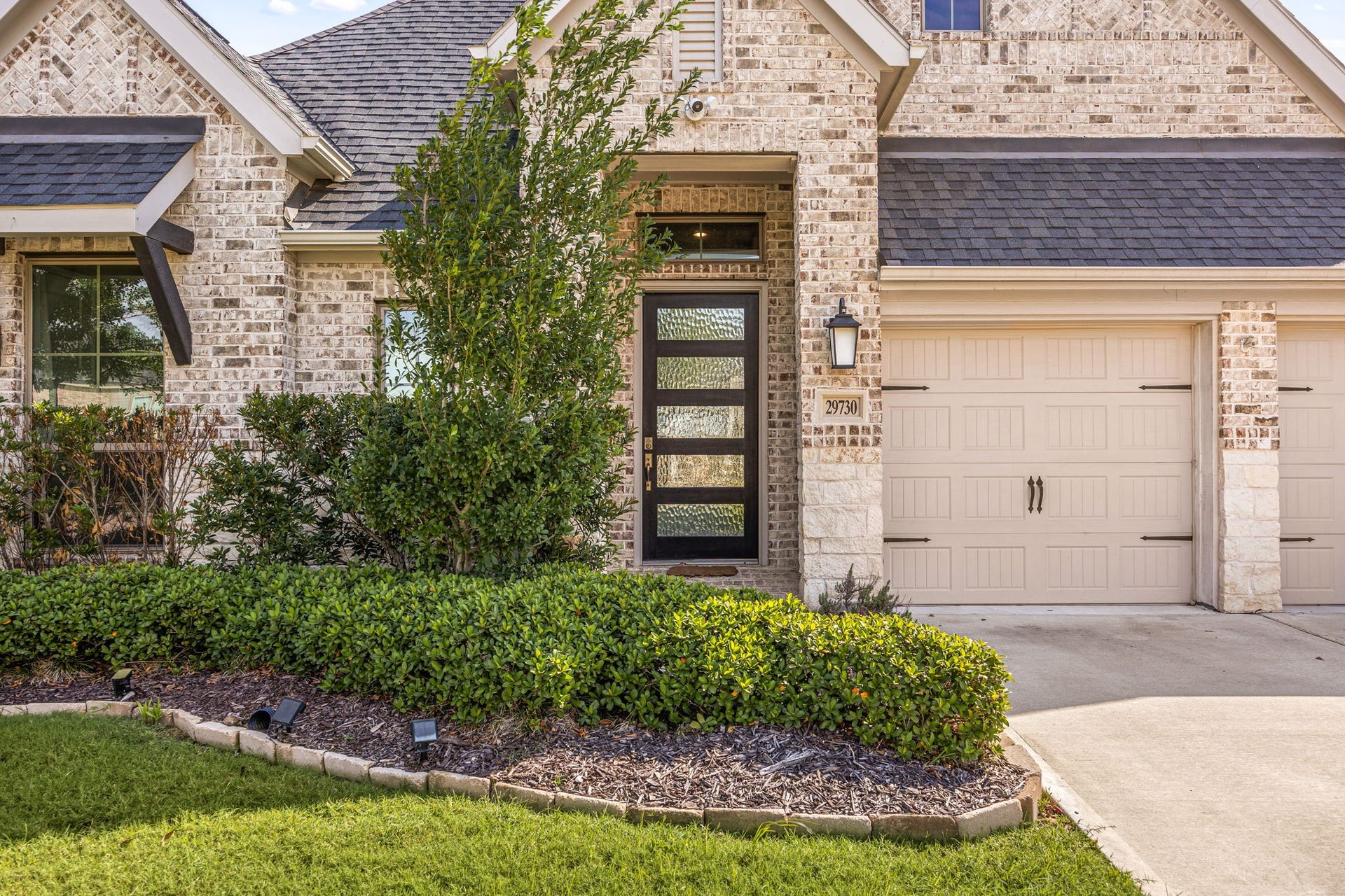 From the street, you are welcomed by a beautiful brick and stone exterior, a double-wide concrete driveway, and a two-car attached garage. Step through the West-facing front door to find your own private escapea backyard garden oasis with no rear neighbors, perfect for quiet mornings or hosting friends.