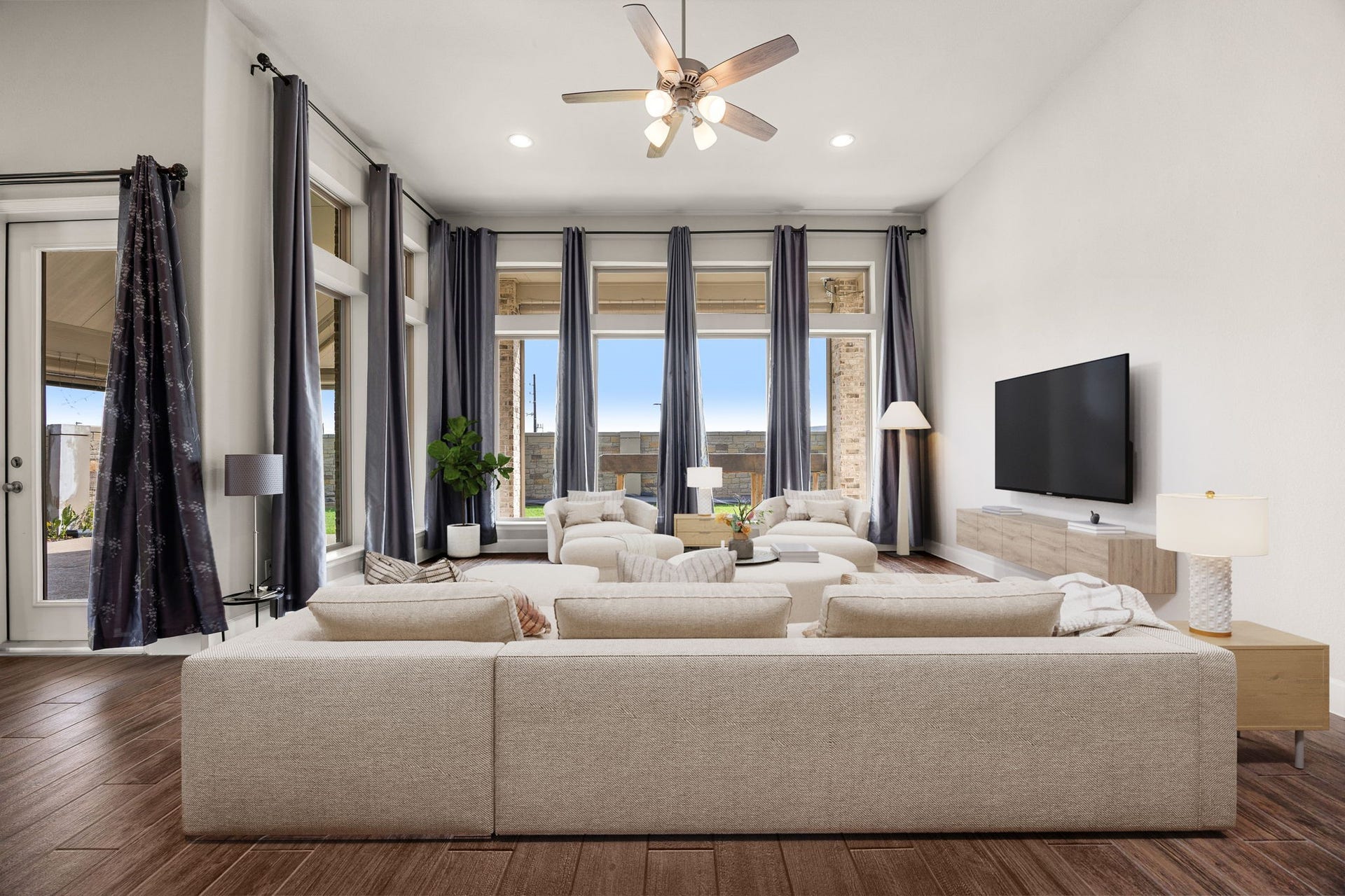 Designed for effortless living and entertaining, this sun-drenched living space seamlessly blends sophistication with comfort. The massive windows offer peaceful views of your private backyard while keeping the layout open, bright, and deeply inviting. *Virtually Staged