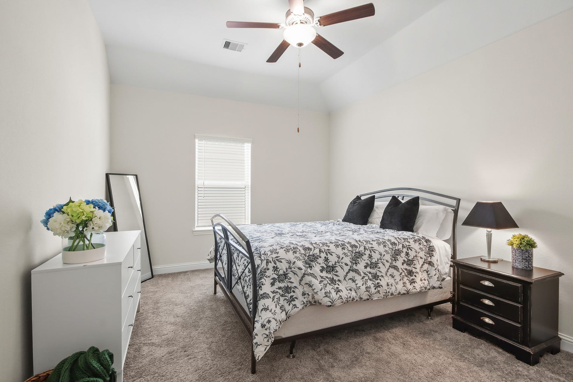 Another secondary bedroom upstairs with neutral carpet, ceiling fan and window for natural light.