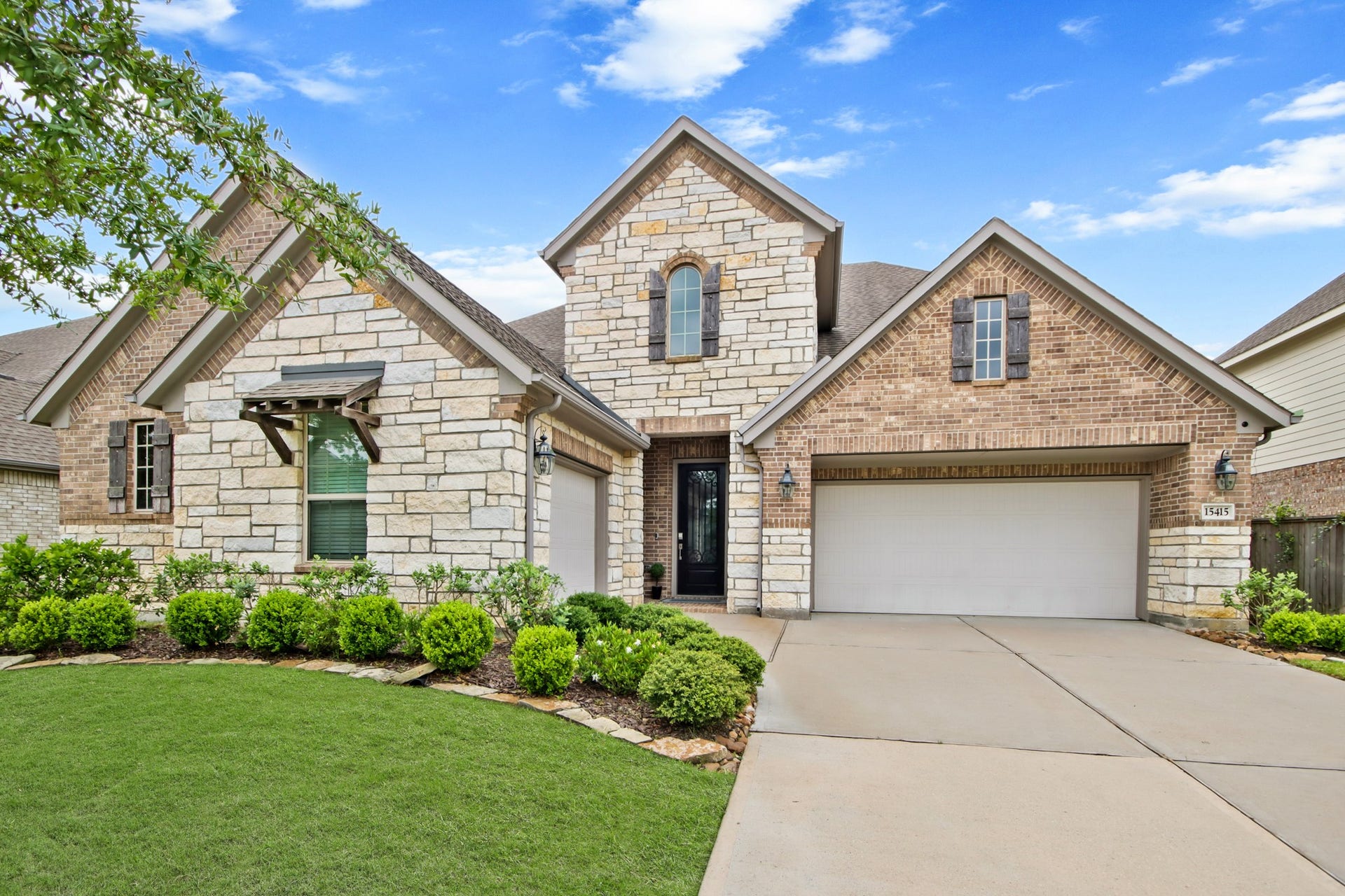 Desirable Acadia Next Gen floor plan with brick and stone elevation.