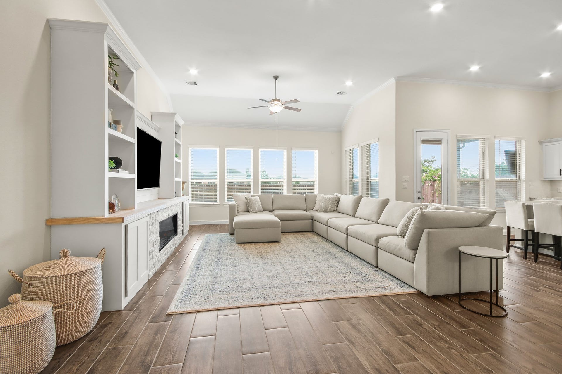 Over sized family room with wall of windows bringing in tons of natural light