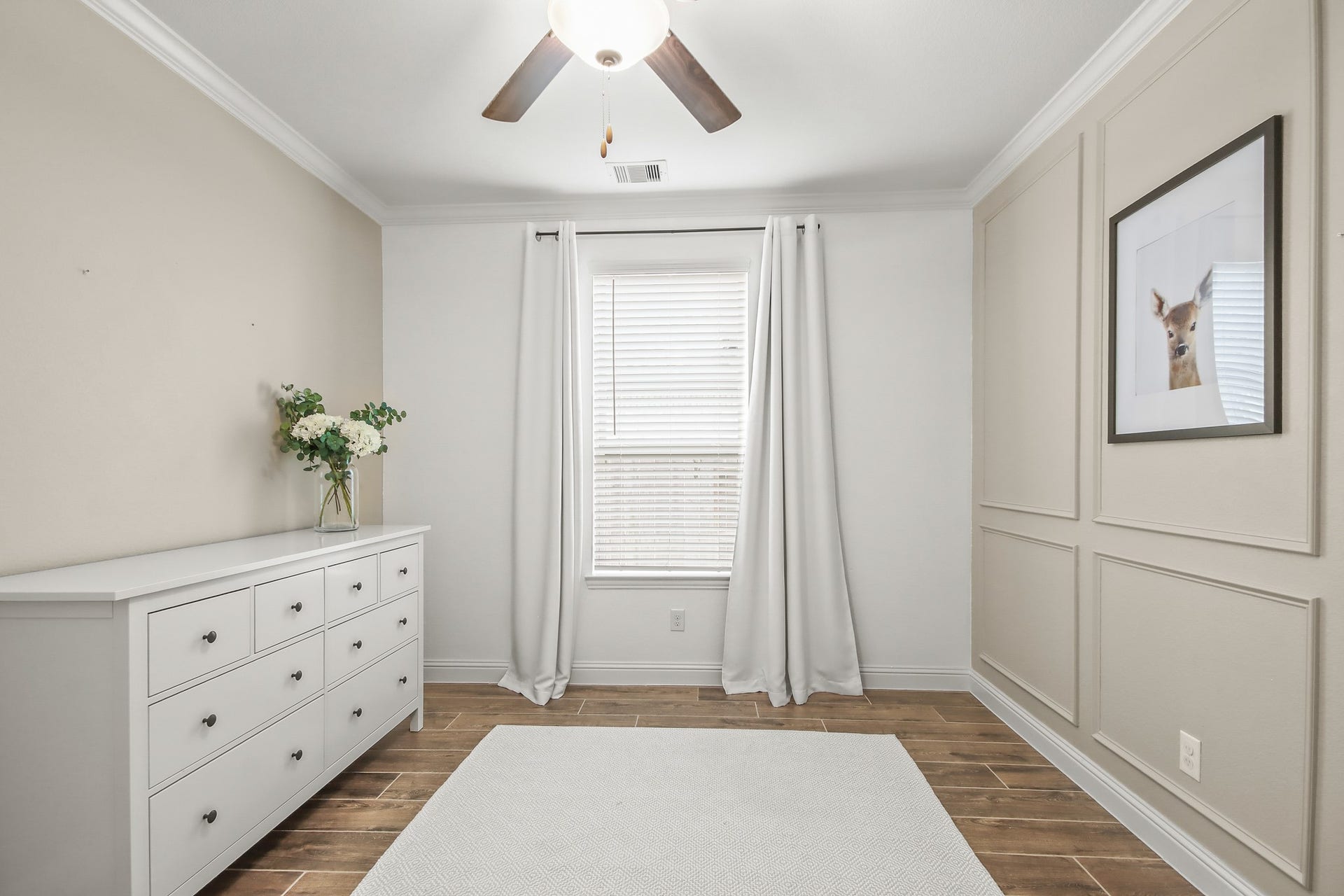 Next Gen bedroom with wood tile flooring and lots of natural light.