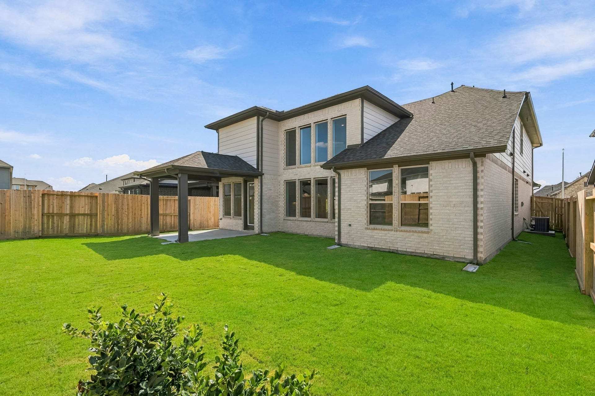 4522 Sunny Hazel Lane, Fulshear, TX 77441 Spacious backyard with a covered patio and plenty of room for outdoor living.