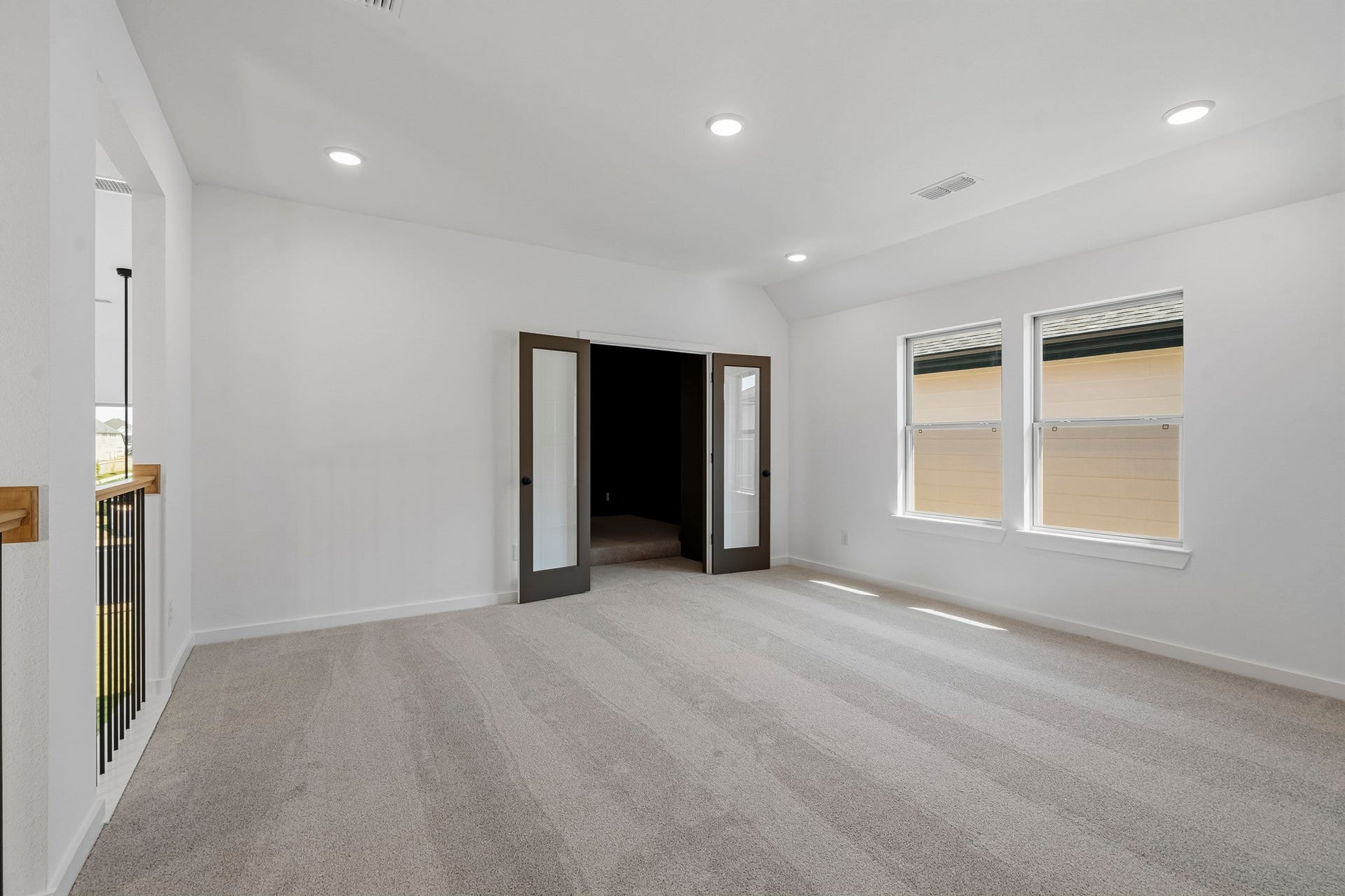 4522 Sunny Hazel Lane, Fulshear, TX 77441 Spacious upstairs game room with glass French doors opening to a dedicated media room.