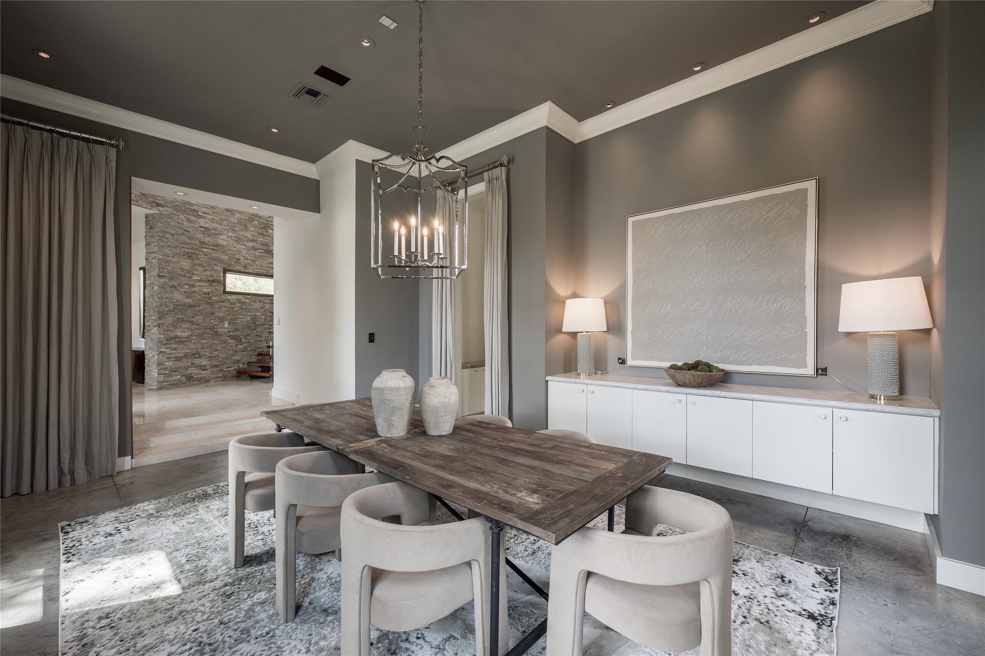 309 Glenwood Drive, Houston, TX 77007 The generous proportions of the formal dining room allow it to accommodate an expansive table while still feeling open and uncluttered. Custom floating cabinetry provides a refined architectural element and functional storage without interrupting the rooms sense of scale.