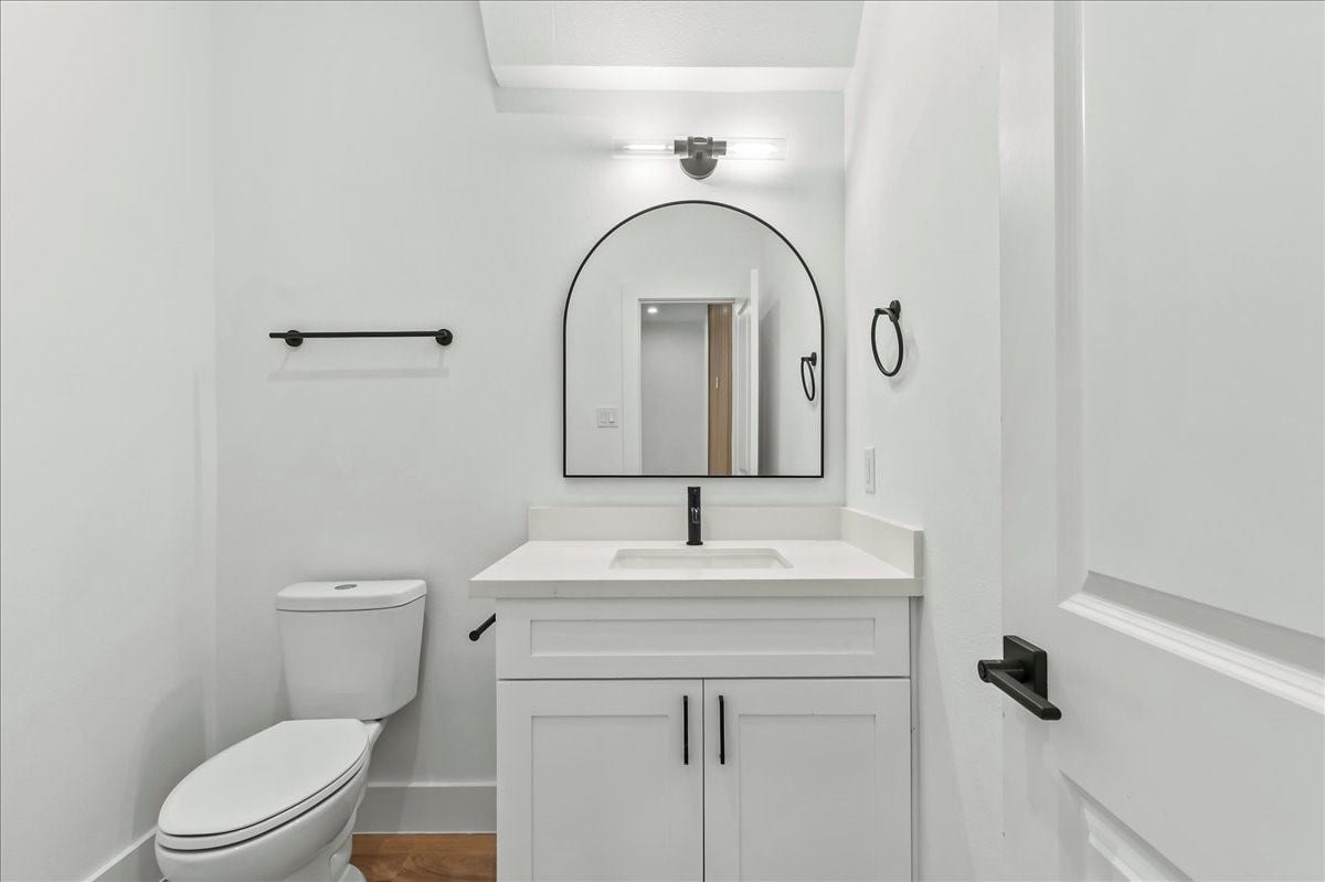 8323 Observatory Street, #A/B, Houston, TX 77088 Unit B - Spacious half bath featuring white quartz countertops, white cabinets, and modern fixtures.