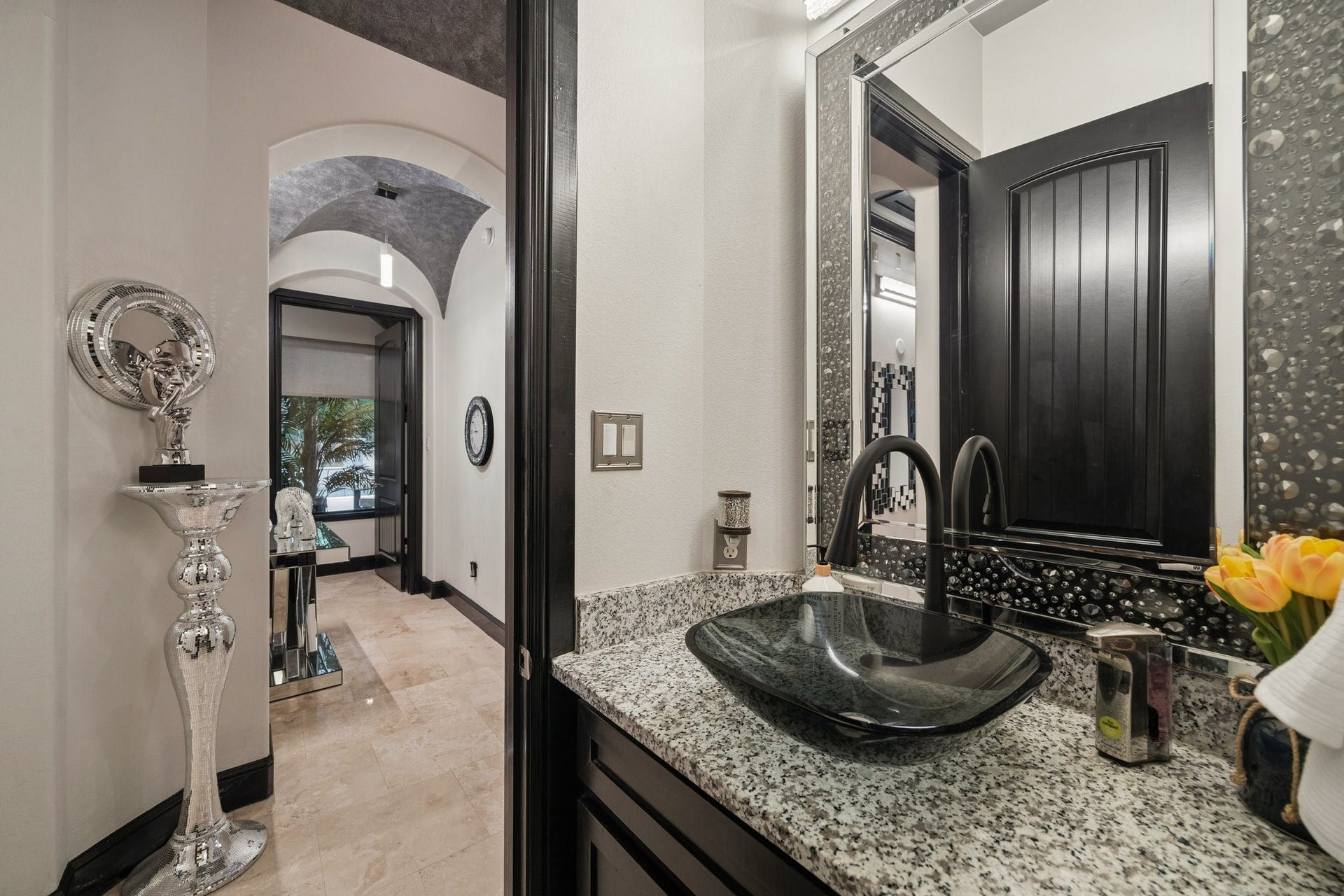 27303 E Benders Landing Boulevard, Spring, TX 77386 Elegant half bath conveniently located off the hallway leading to the bedrooms. This stylish space features a modern vessel sink, granite countertop, designer faucet, a refined framed mirror.