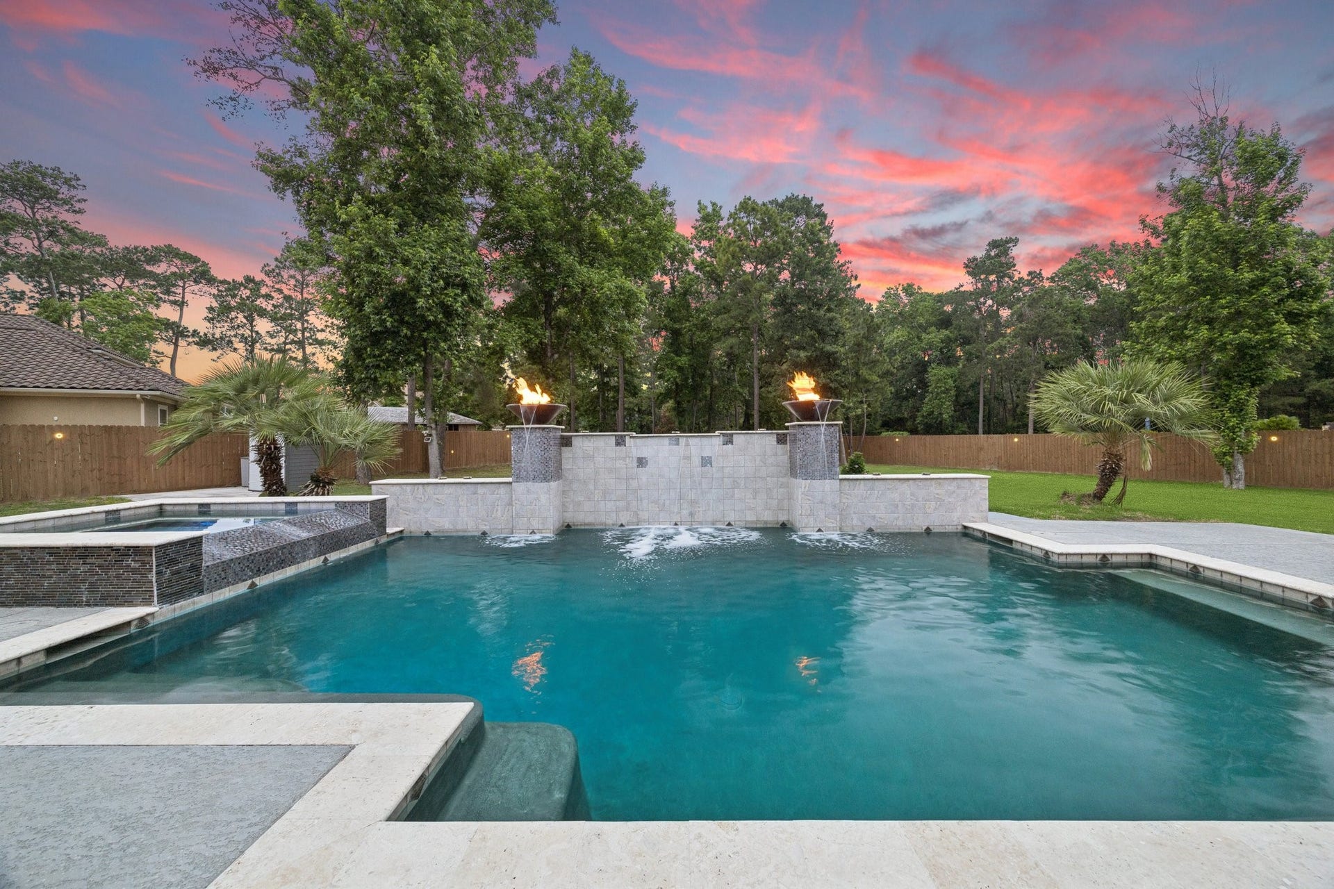 27303 E Benders Landing Boulevard, Spring, TX 77386 Enjoy resort-style outdoor living with a sparkling pool and relaxing spa designed for year-round enjoyment with a heating feature. Elegant fire bowls, water features, tree line backdrop creates the perfect setting to unwind or entertain in your own private retreat.