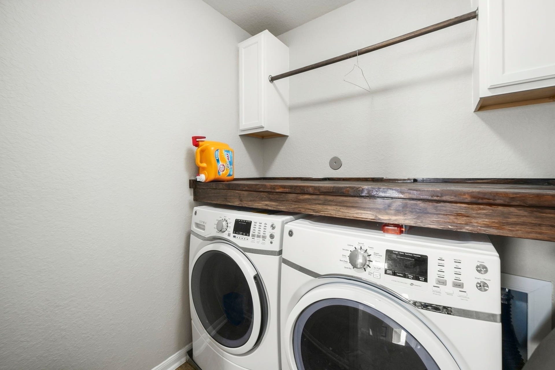 Laundry Room: Dedicated laundry room provides upper cabinetry, hanging space and a substantial countertop above the washer and dryer.