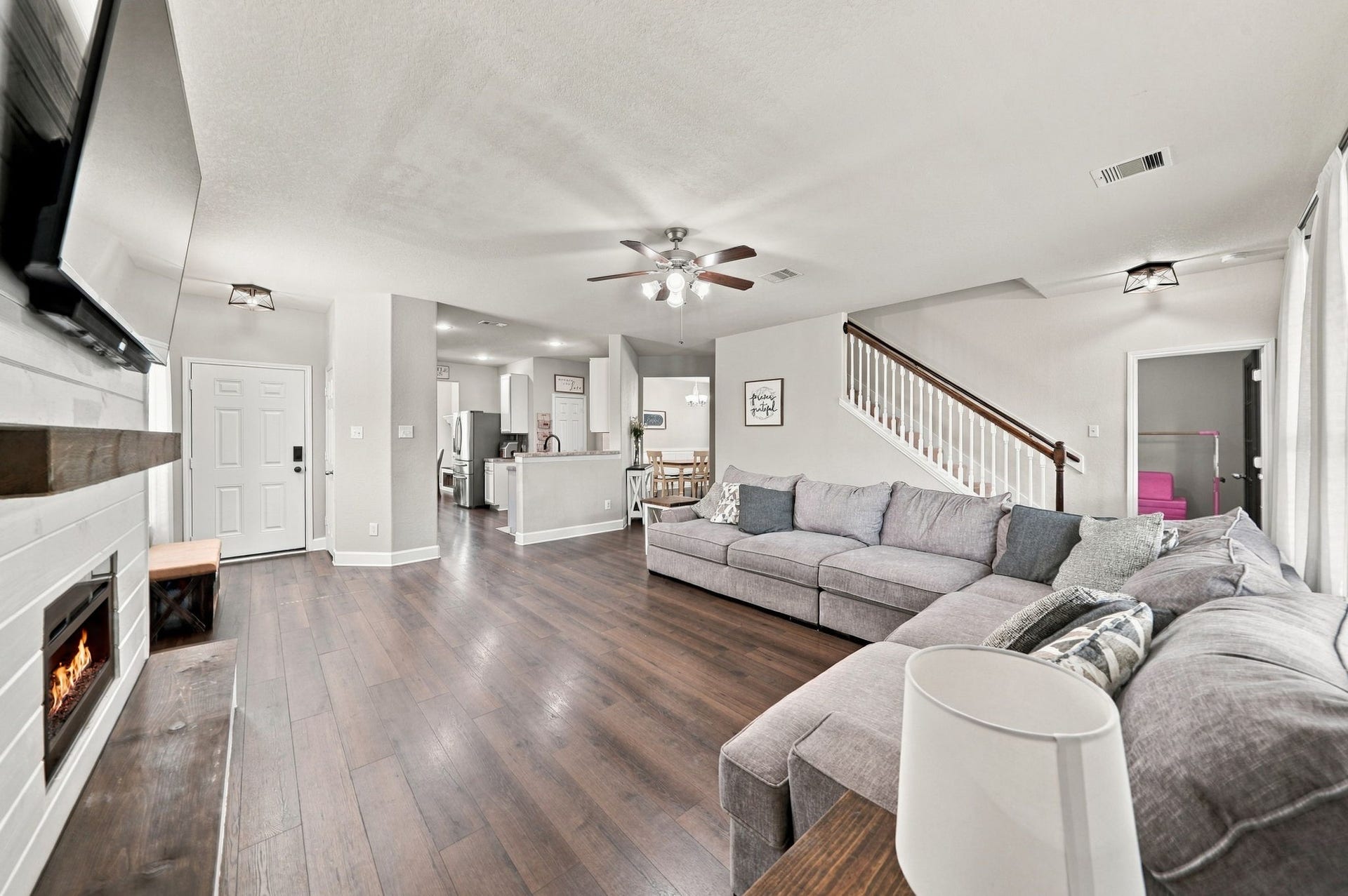 Open Floor Plan: Wide-angle view captures the seamless connection between the living room, kitchen and dining areas for effortless everyday living and entertaining.