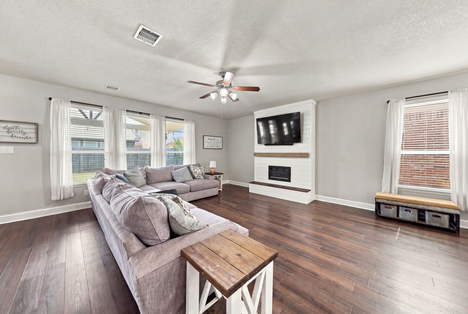 Living Room: Another view emphasizes the generous proportions, abundant windows and open space surrounding the central fireplace.