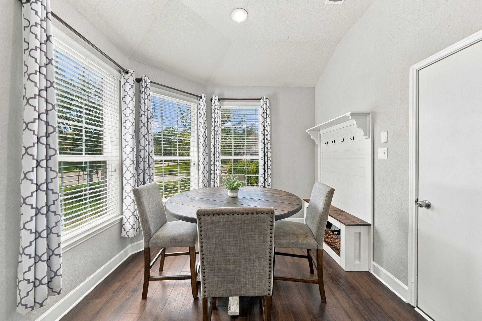 Breakfast Area: Charming breakfast space surrounded by windows brings abundant natural light into the room.