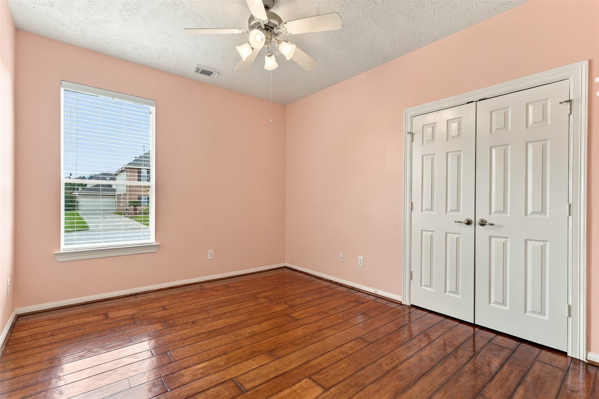 6522 Pine Reserve Drive, Spring, TX 77389 Cozy secondary bedroom with ample natural light and elegant wood flooring.