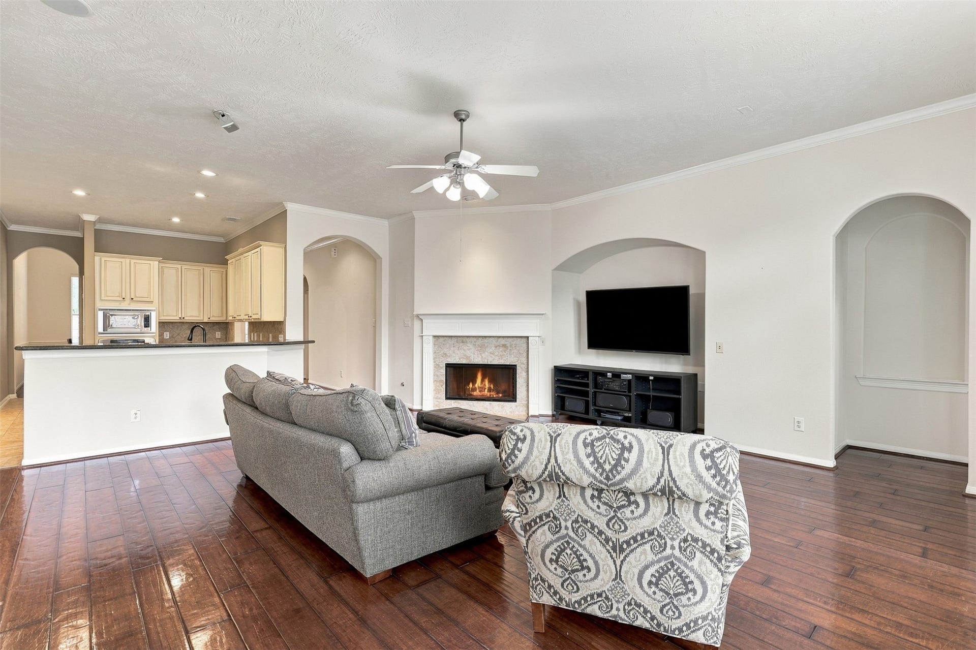 6522 Pine Reserve Drive, Spring, TX 77389 Cozy living room with a gas fireplace and a custom TV niche.
