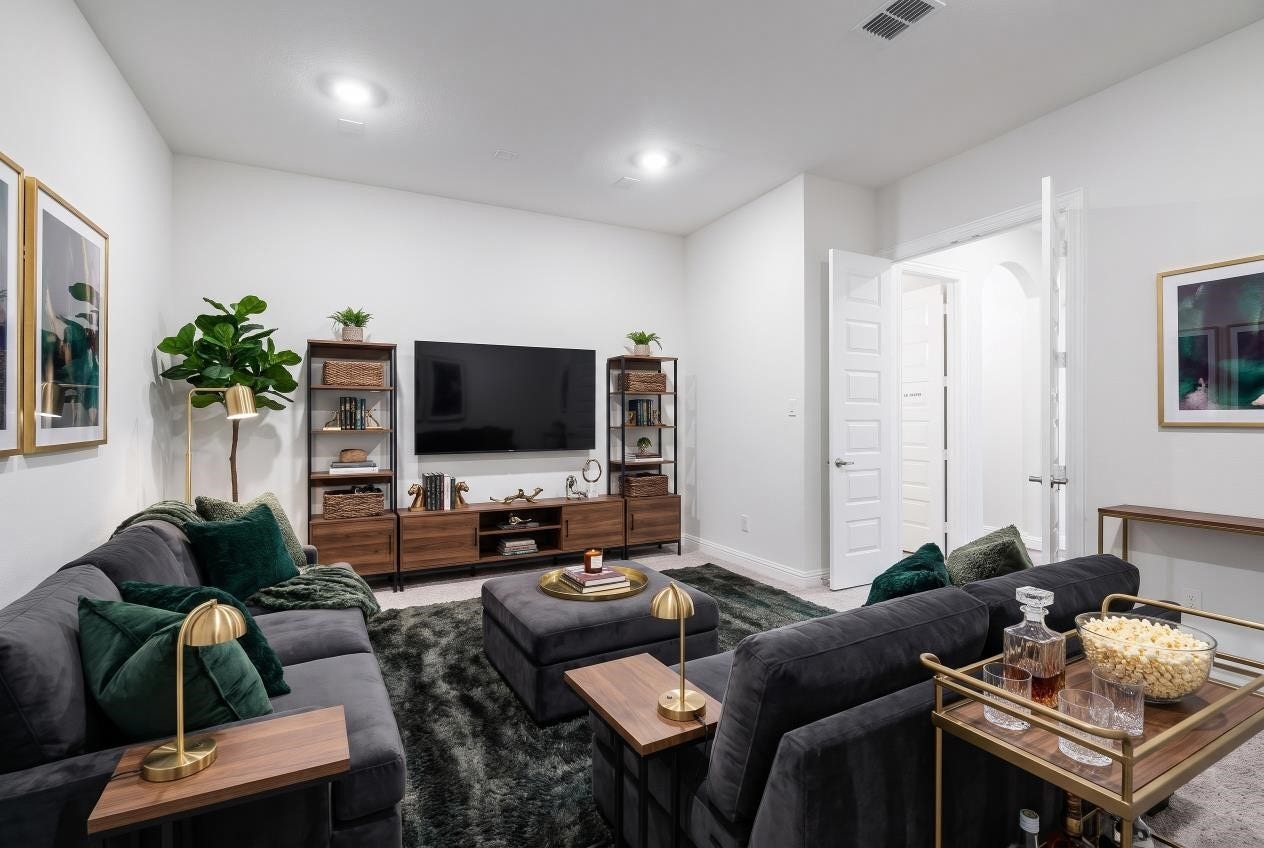 Virtual staging of the first-floor media room. It's the perfect open space for movie nights and entertaining, with existing wiring ready for your own customized audio and video systems.