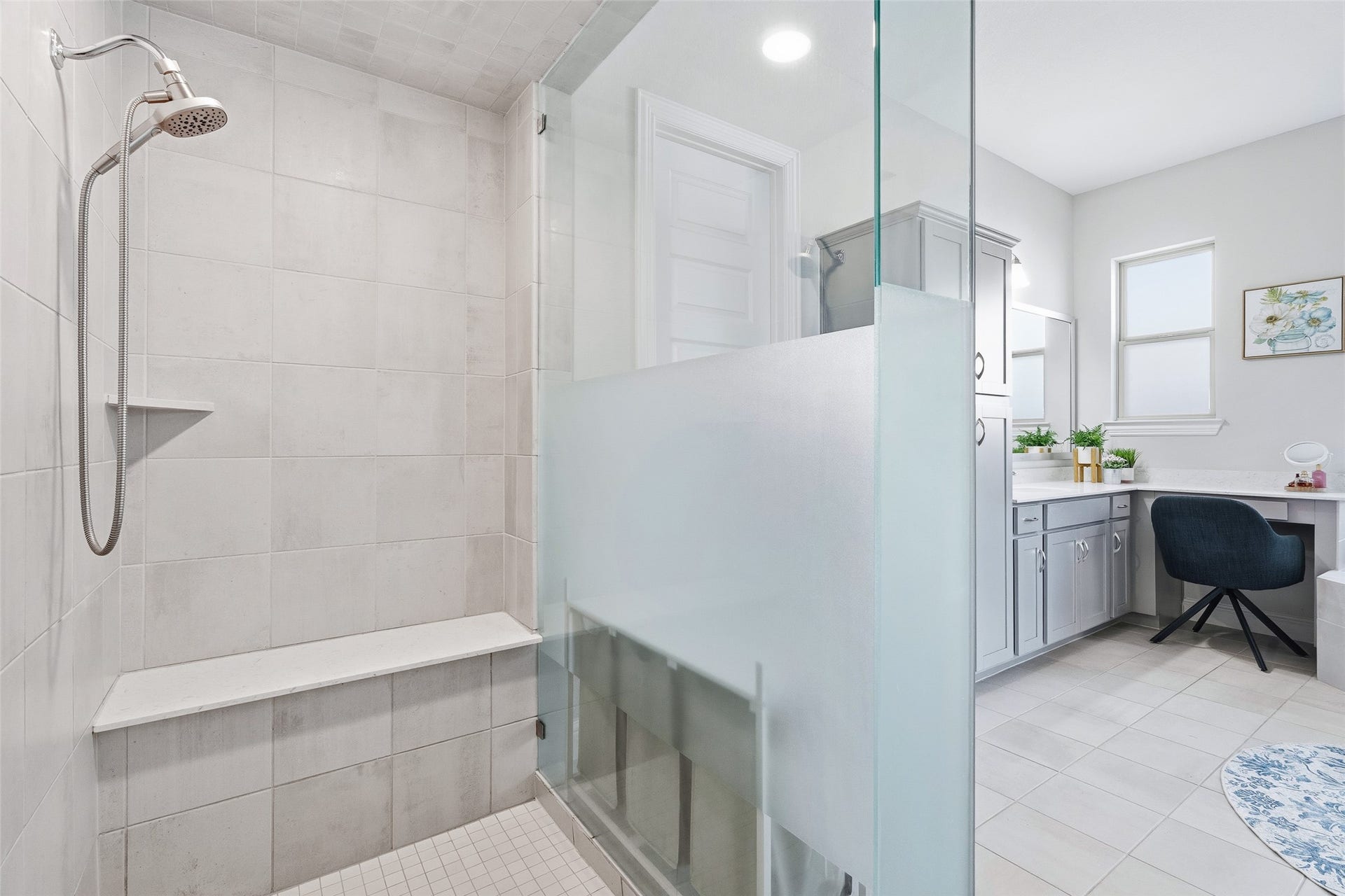 A spacious en suite bath offers dual sinks, storage, private toilet, a large soaking tub, separate shower with bench, vanity, and 2 large walk-in closets with ample storage and access to the laundry room.