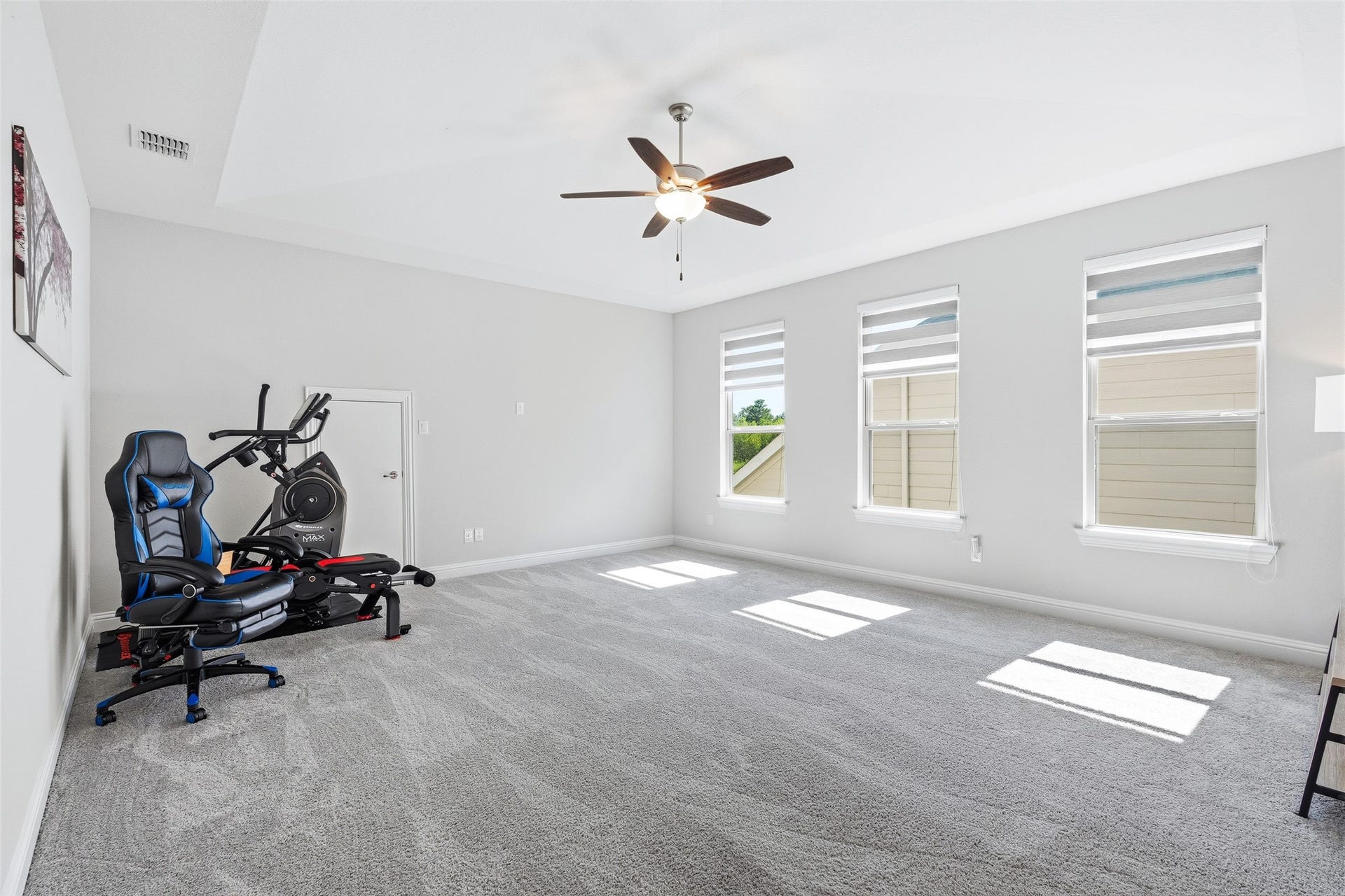 This spacious second-floor game room that offers flexible living space, perfect for entertaining, a game room, or a third living area.