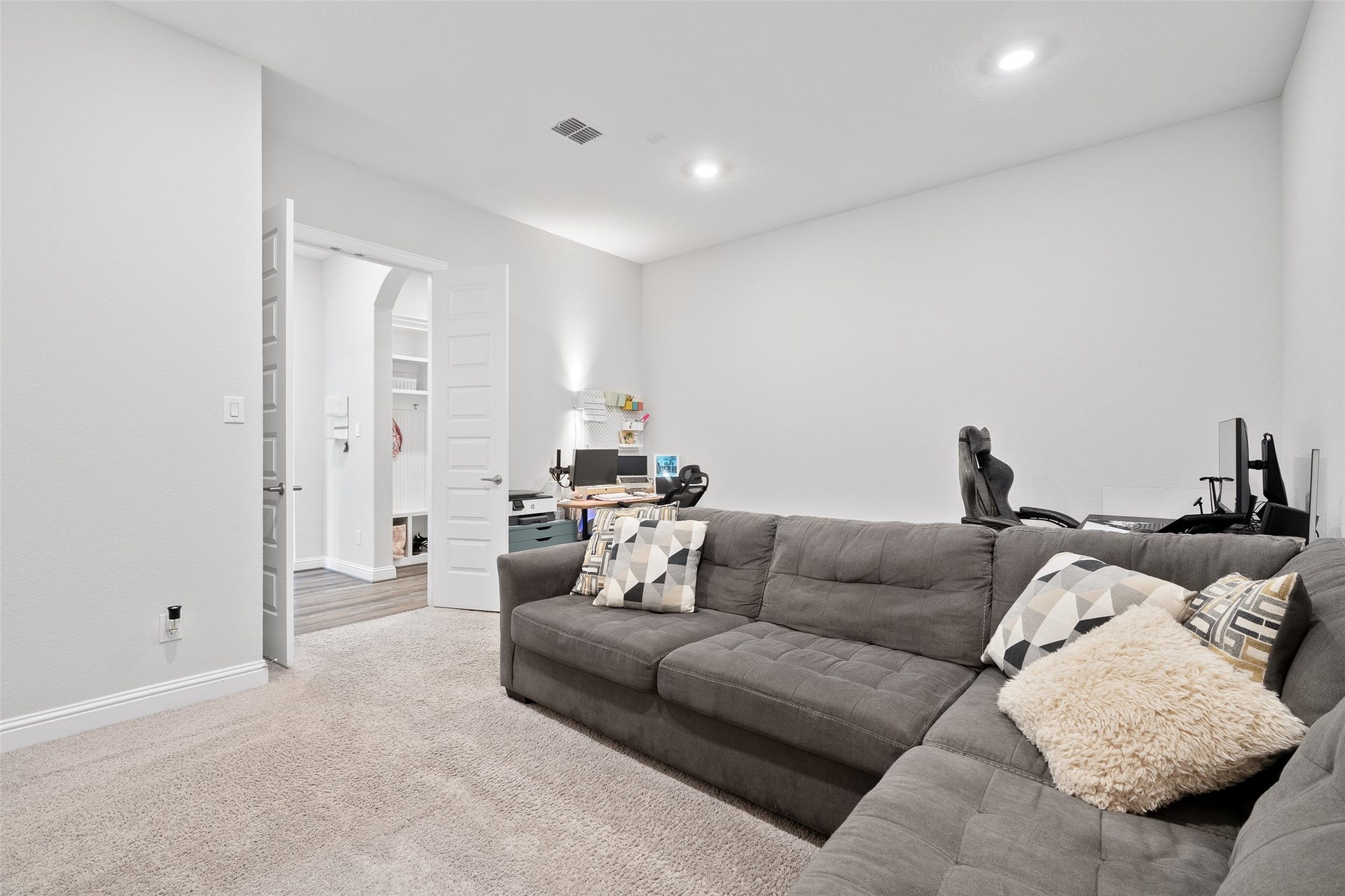 View 2 of the first-floor media room. It's the perfect open space for movie nights and entertaining, with existing wiring ready for your own customized audio and video systems.