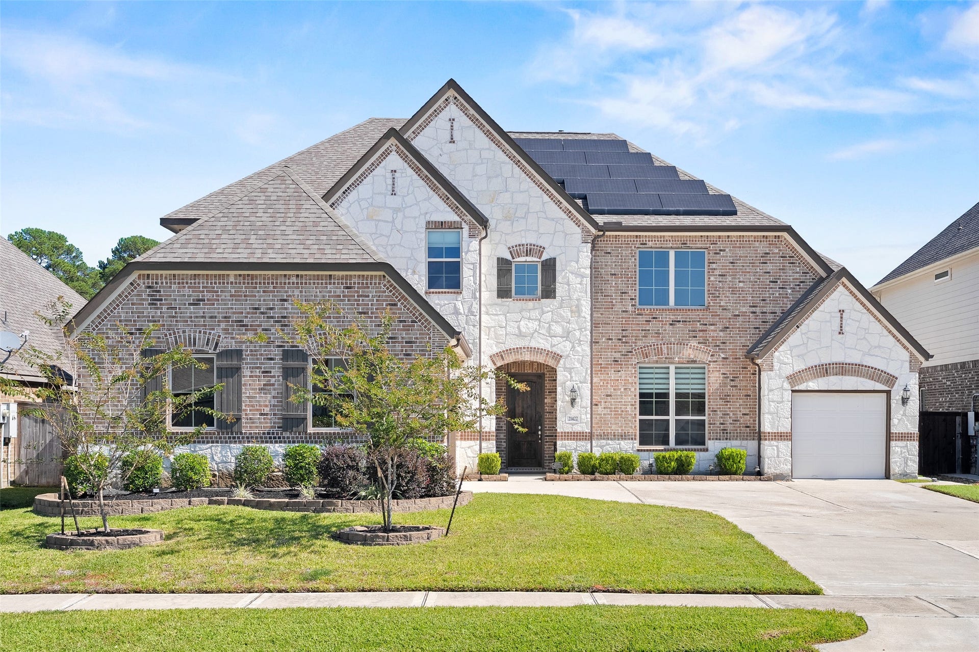 The split-garage design and extended driveway provide ample off-street parking in a low-traffic part of the subdivision.