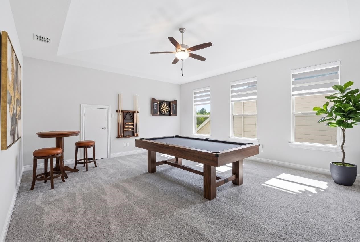 Virtual staging of this spacious second-floor game room that offers flexible living space, perfect for entertaining, a game room, or a third living area.
