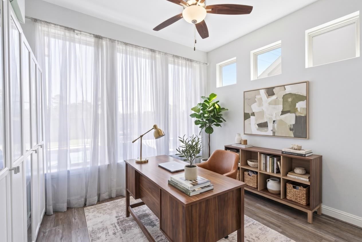 Virtual staging of the first-floor sunroom overlooking the pool offers versatile space for a home office, flex space, or fourth living area.