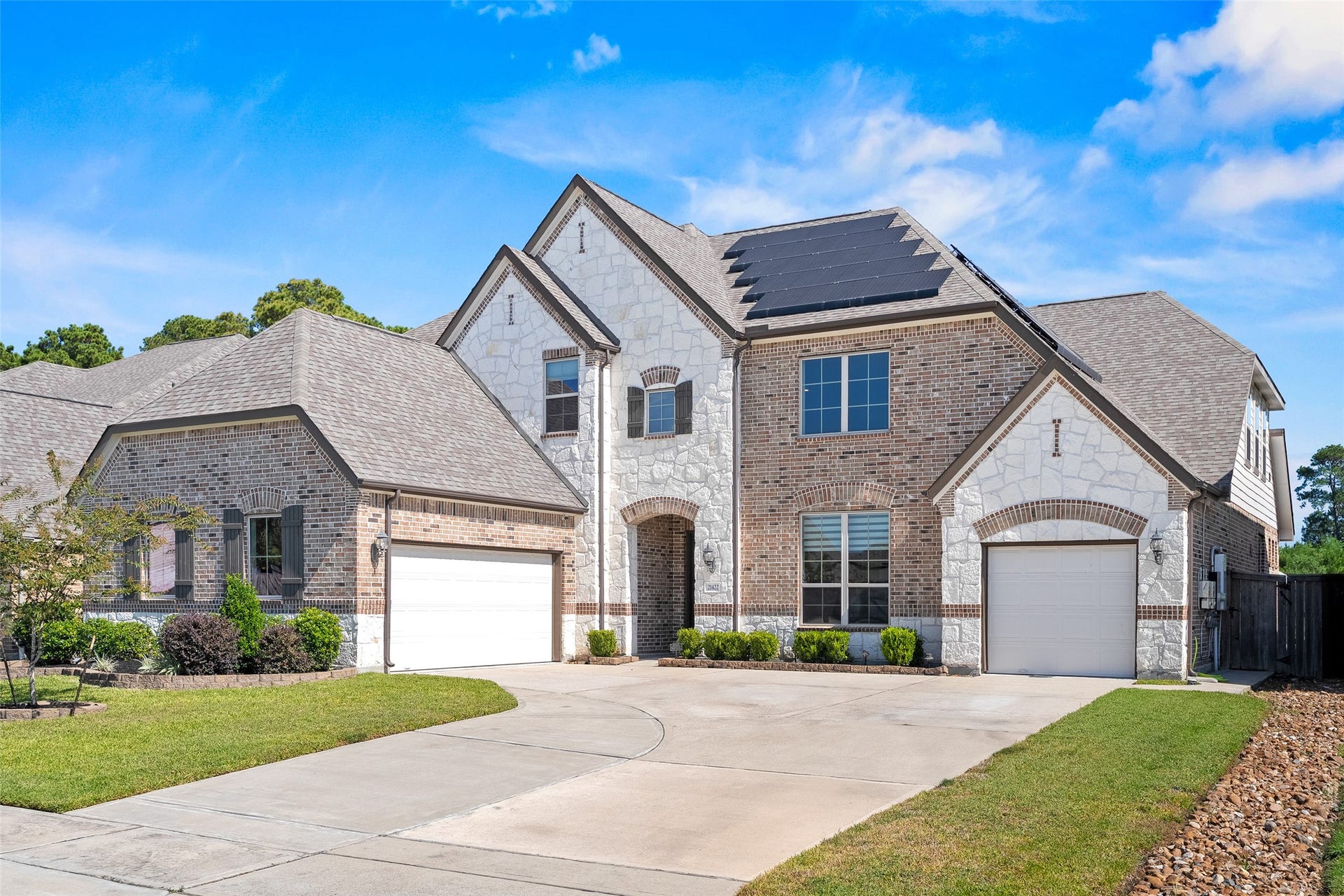 The split-garage design and extended driveway provide ample off-street parking in a low-traffic part of the subdivision.