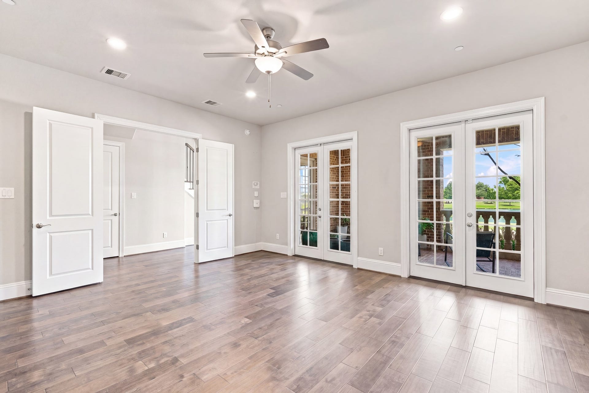 183 Grace Point Drive, Sugar Land, TX 77498 First floor flex room, rich wood flooring, large walk-in closet , en-suite bathroom & 2 sets of french doors to your own private balcony with lake views!