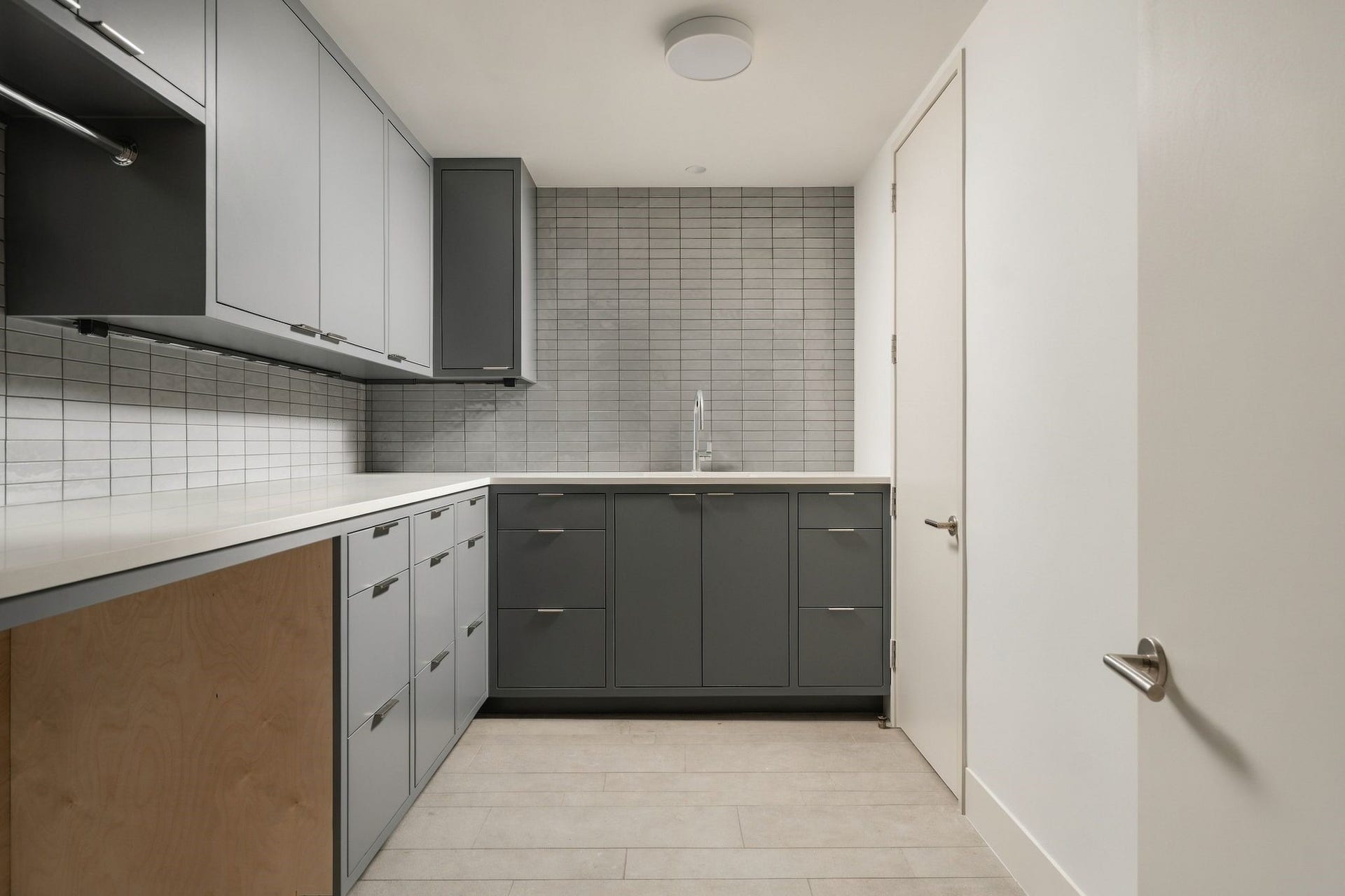 Dedicated primary utility room is conveniently located upstairs w/the bedrooms & thoughtfully equipped w/quartz countertops, porcelain subway tile backsplash, utility sink, drying rod, abundant cabinetry & a separate storage closetmaking everyday laundry functional & beautifully organized.