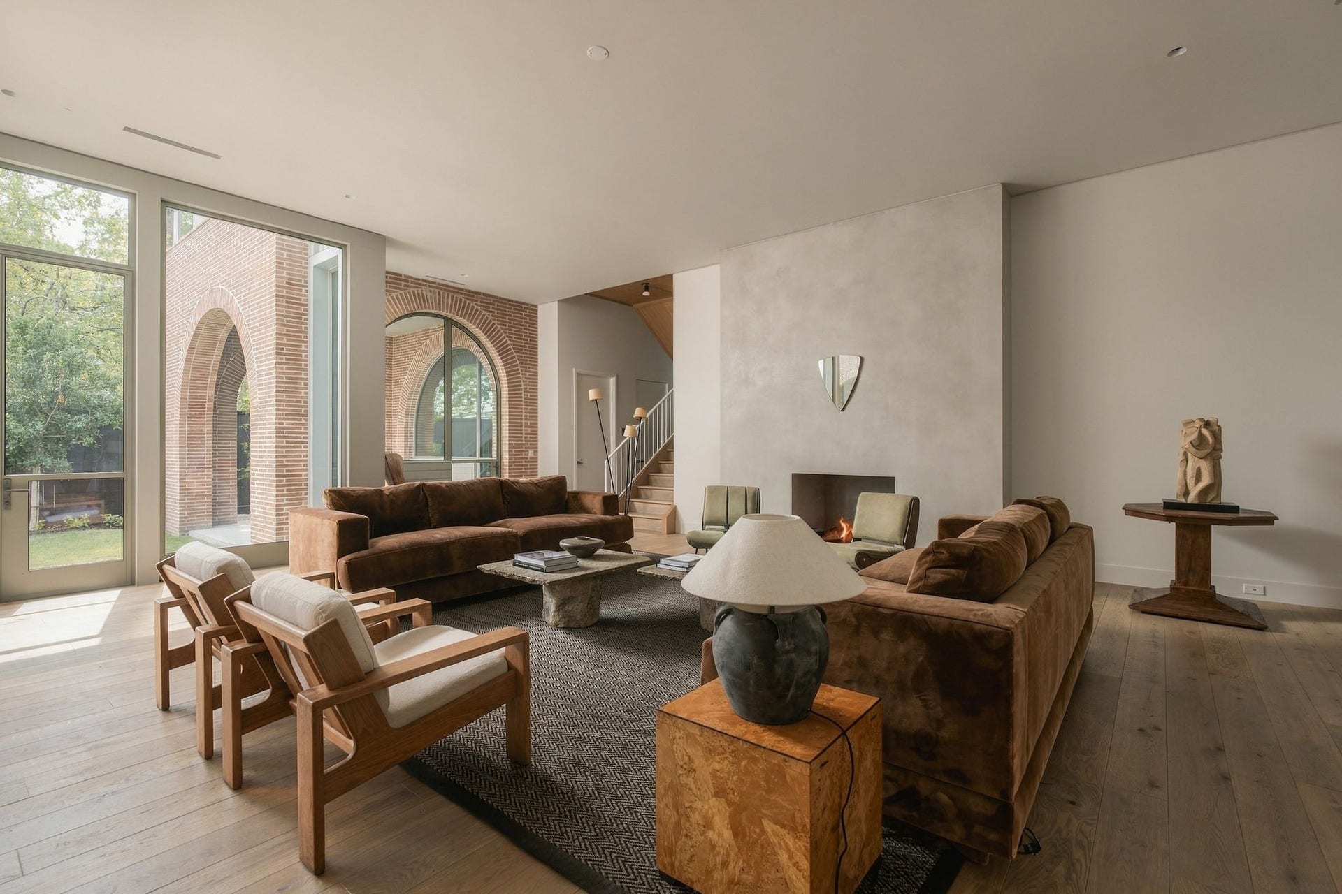 Generous proportions allow for multiple furniture configurations without sacrificing the intimacy of the room. European white oak floors, clean ceiling lines & an arched transition to the covered patio create a refined backdrop while maintaining the homes effortless indoor-outdoor connection.