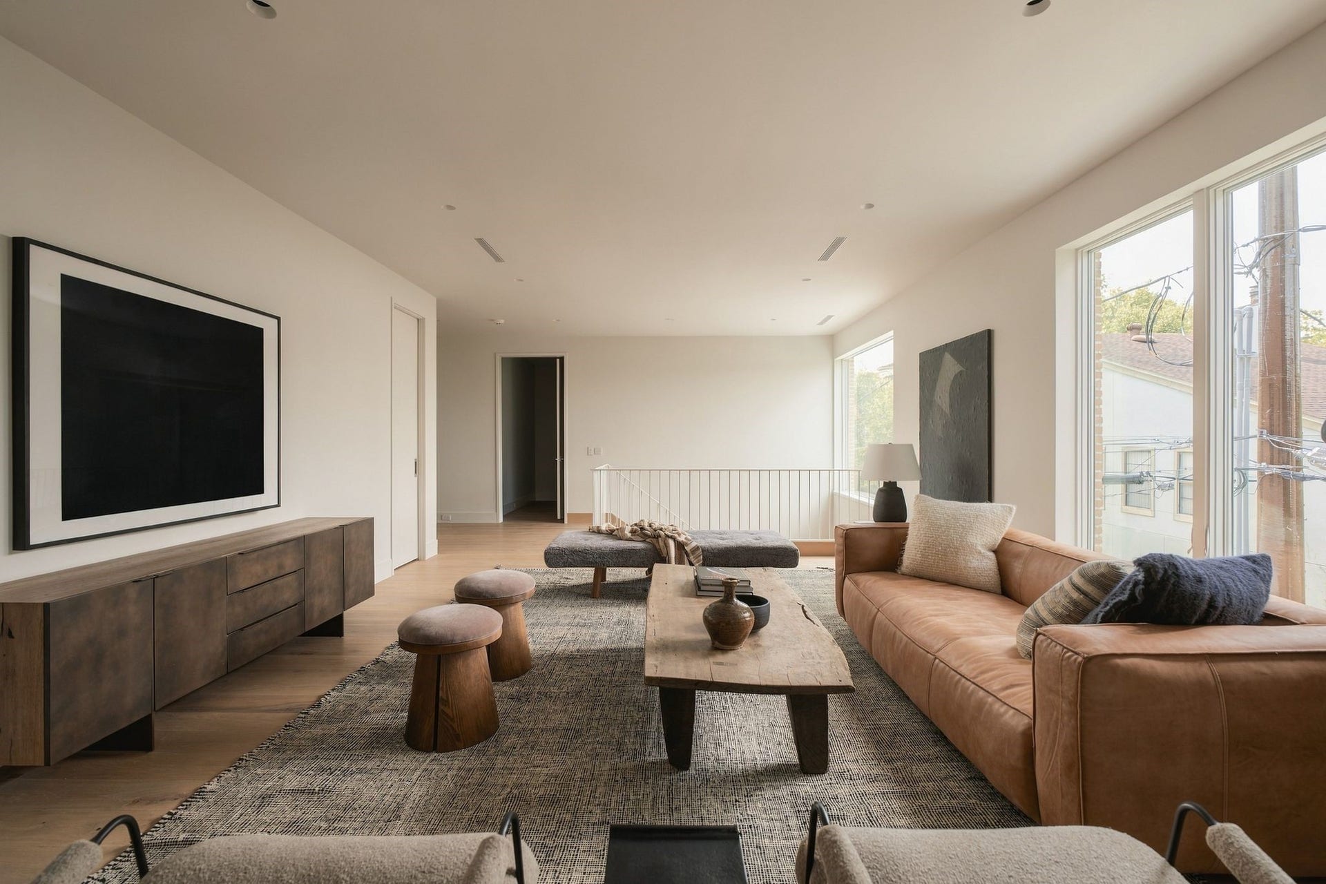 Large windows bring beautiful natural light into the second-floor landing/game room, while the nearby elevator shaft is currently configured as a generous storage closet. The home is elevator-capable, providing flexibility for future owners.