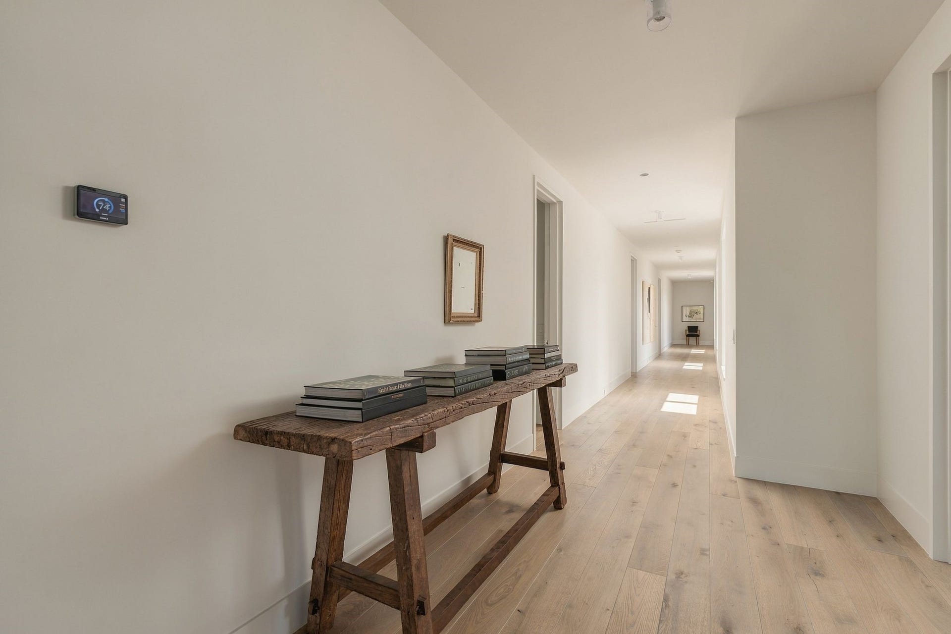 The architectural emphasis on natural light continues upstairs, where windows line the bedroom hallway & provide leafy views outside. Clean lines, European white oak floors & thoughtfully placed openings keep the private bedroom level feeling bright & connected to the landscape.