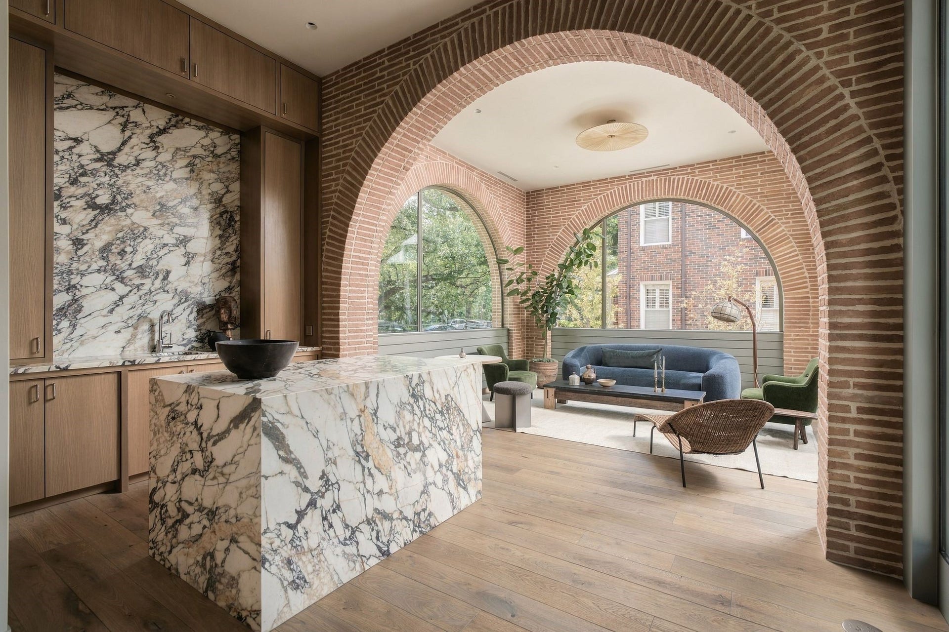 Designed as a true procession rather than a series of traditional hallways, each space leads naturally into the next. From the entry, the jewel-box wet bar opens to the breathtaking parlour beyond, where arched steel windows frame the landscape & draw you further into the home.